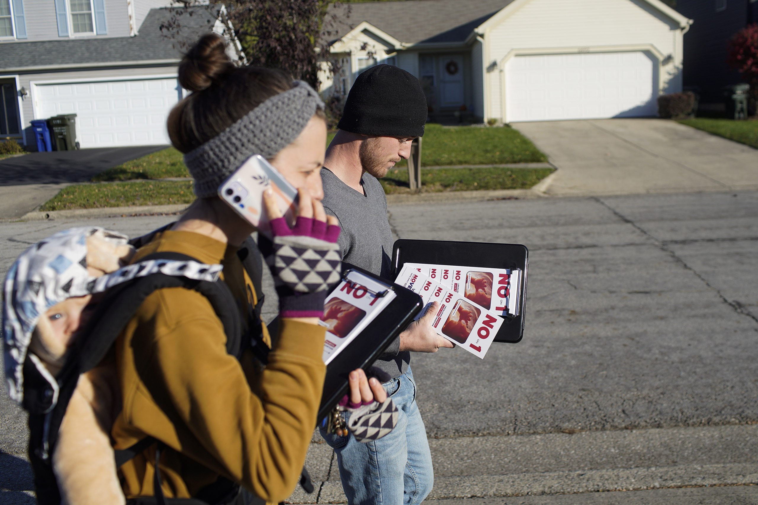 COLUMBUS, OHIO - NOVEMBER 3: Titus Meyer (R), and Elizabeth McCulfor (L), employees of anti-abortion organization Created Equal, walk with daughter Willow on November 3, 2023 in Canal Winchester, Ohio. Ohioans will vote on Issue 1, officially titled “The Right to Reproductive Freedom with Protections for Health and Safety,” which would codify reproductive rights in the Ohio Constitution, including contraception, fertility treatment and the right to abortion up to the point of fetal viability while permitting restrictions after. (Photo by Andrew Spear/Getty Images)