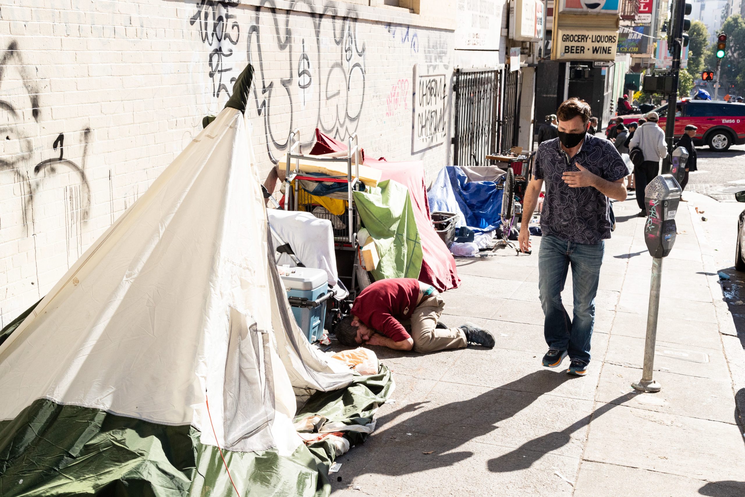 People and their belongings are seen on Jones Street in San Francisco, on November 13, 2023. San Francisco has struggled to clean up the city ahead of hosting world and business leaders. (Photo by Jason Henry / AFP) (Photo by JASON HENRY/AFP via Getty Images)