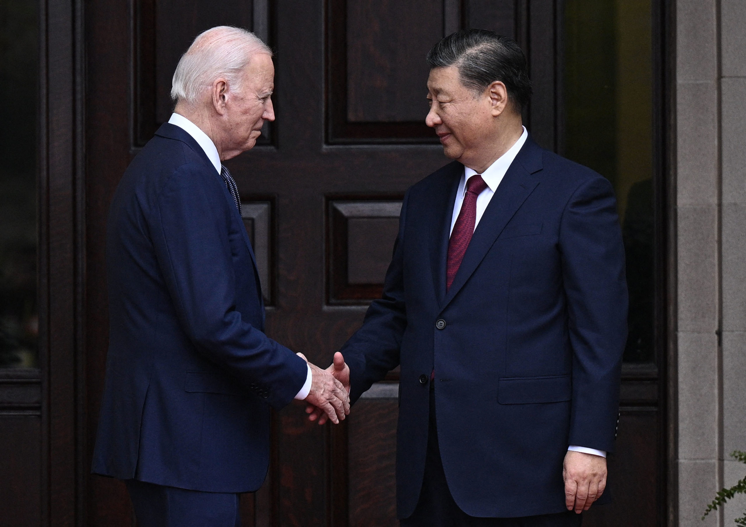US President Joe Biden greets Chinese President Xi Jinping before a meeting during the Asia-Pacific Economic Cooperation (APEC) Leaders' week in Woodside, California on November 15, 2023. Biden and Xi will try to prevent the superpowers' rivalry spilling into conflict when they meet for the first time in a year at a high-stakes summit in San Francisco on Wednesday. With tensions soaring over issues including Taiwan, sanctions and trade, the leaders of the world's largest economies are expected to hold at least three hours of talks at the Filoli country estate on the city's outskirts. (Photo by Brendan SMIALOWSKI / AFP) (Photo by BRENDAN SMIALOWSKI/AFP via Getty Images)