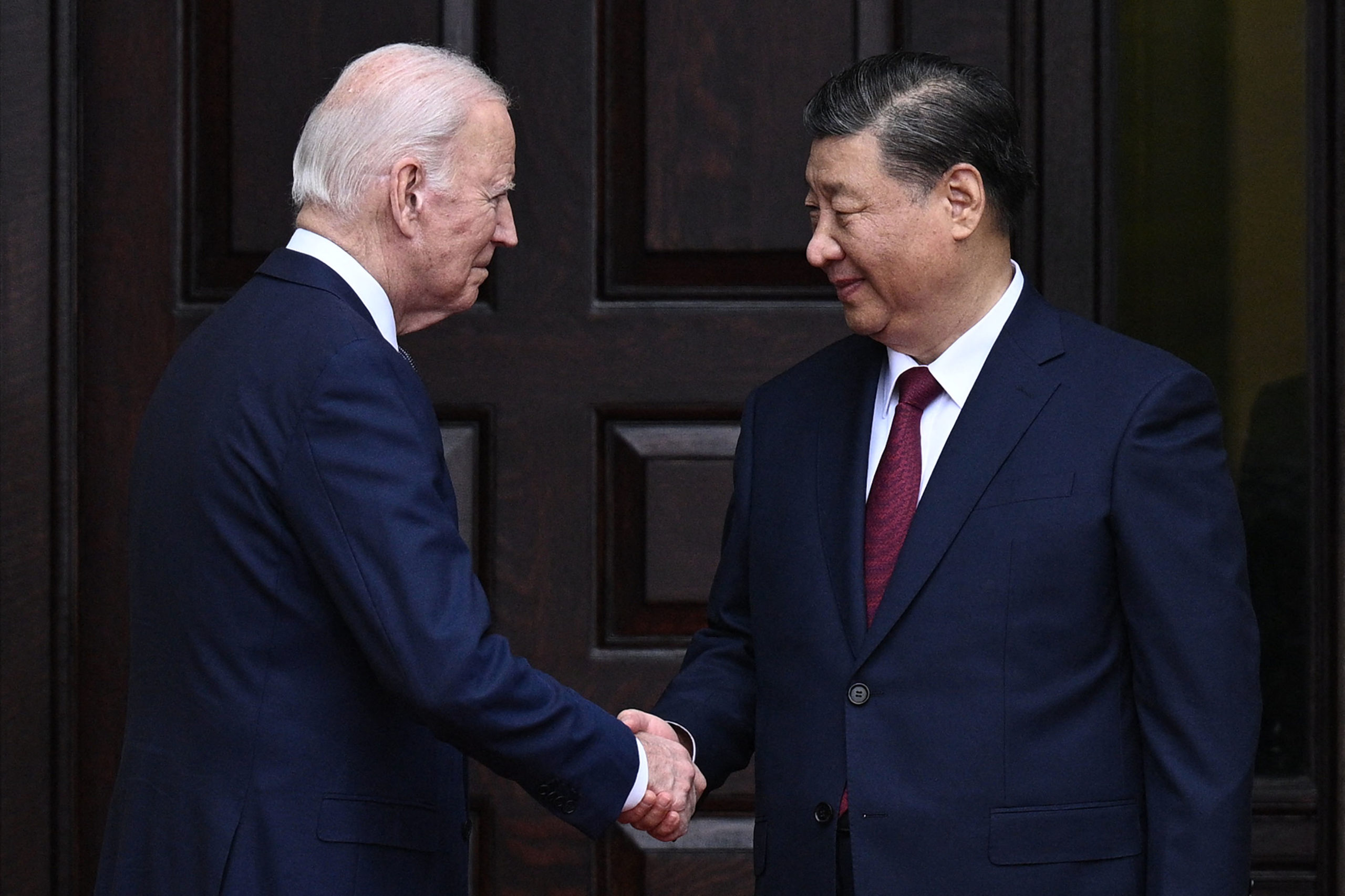 US President Joe Biden greets Chinese President Xi Jinping before a meeting during the Asia-Pacific Economic Cooperation (APEC) Leaders' week in Woodside, California on November 15, 2023. Biden and Xi will try to prevent the superpowers' rivalry spilling into conflict when they meet for the first time in a year at a high-stakes summit in San Francisco on Wednesday. With tensions soaring over issues including Taiwan, sanctions and trade, the leaders of the world's largest economies are expected to hold at least three hours of talks at the Filoli country estate on the city's outskirts. (Photo by Brendan SMIALOWSKI / AFP) (Photo by BRENDAN SMIALOWSKI/AFP via Getty Images)