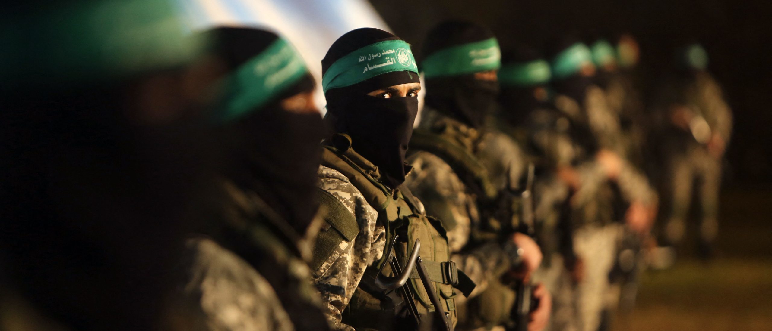 TOPSHOT - Palestinian members of the Ezzedine al-Qassam Brigades, the armed wing of the Hamas movement, take part in a gathering on January 31, 2016 in Gaza city to pay tribute to their fellow militants who died after a tunnel collapsed in the Gaza Strip. Seven Hamas militants were killed on January 28, 2016 after a tunnel built for fighting Israel collapsed in the Gaza Strip, highlighting concerns that yet another conflict could eventually erupt in the Palestinian enclave. (Photo by MAHMUD HAMS / AFP) (Photo by MAHMUD HAMS/AFP via Getty Images)