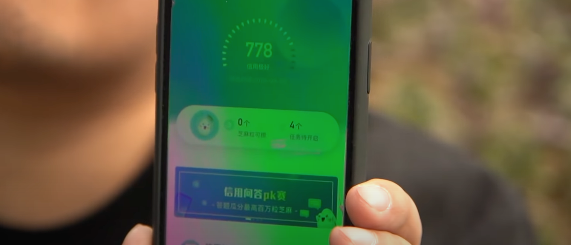 A man in China shows his score on the Sesame Social Credit System. [Screenshot/YouTube/France24English]