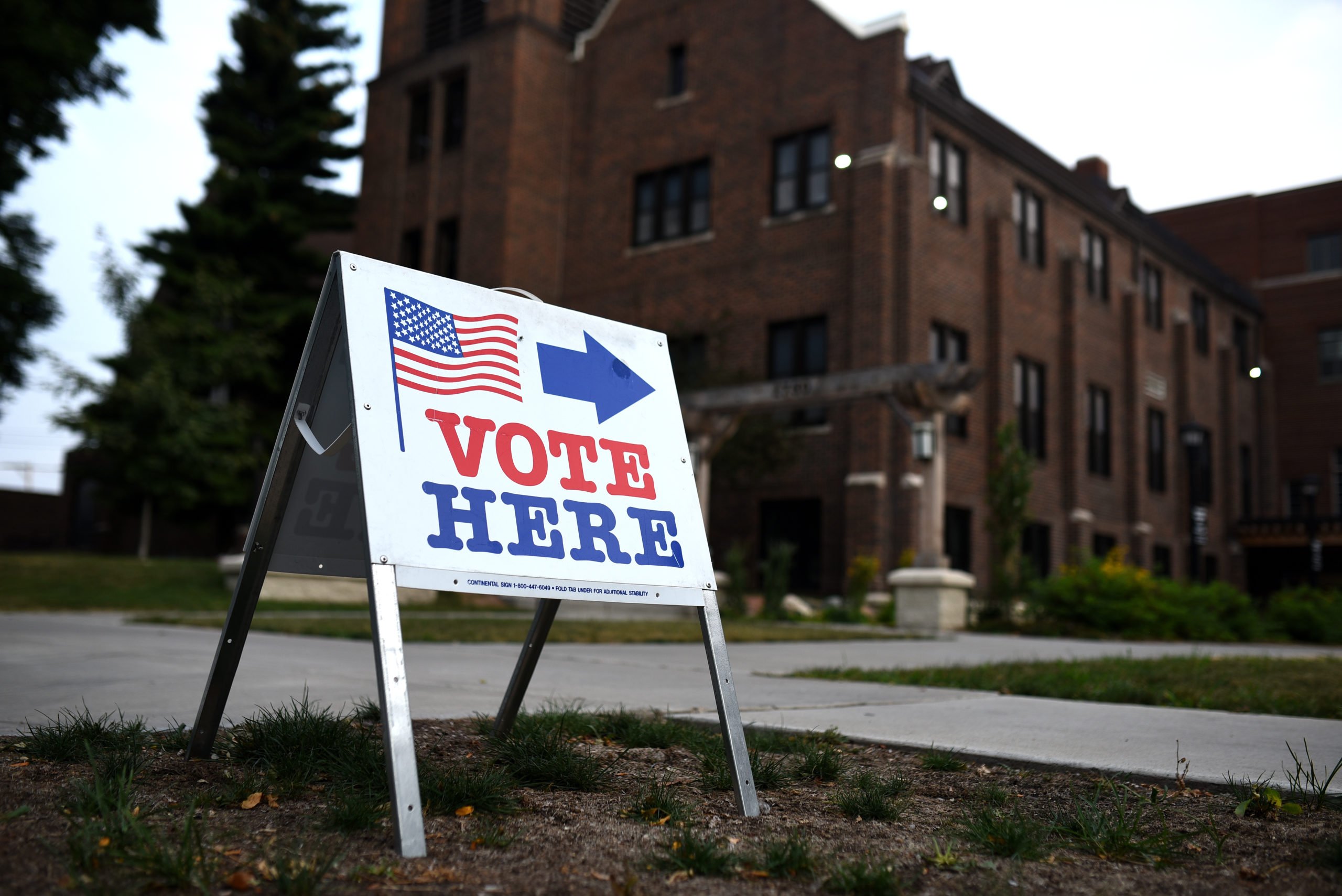 MINNEAPOLIS, MN - AUGUST 14: A sign reading "Vote Here" points toward a polling place for the 2018 Minnesota primary election at Holy Trinity Lutheran Church on August 14, 2018 in Minneapolis, Minnesota. (Photo by Stephen Maturen/Getty Images)