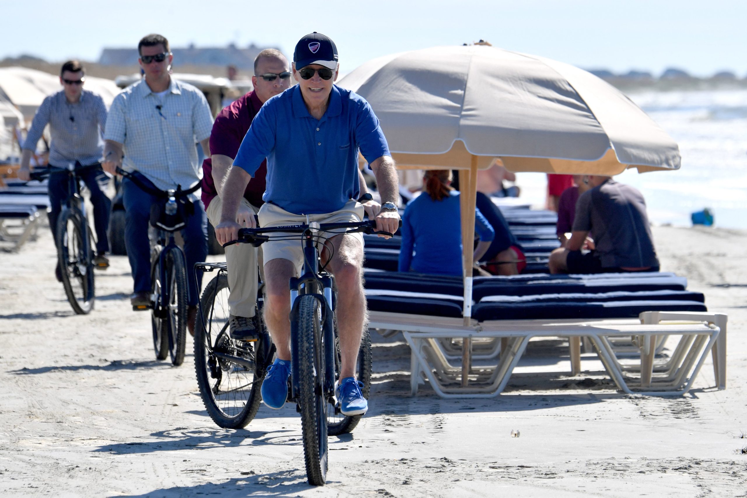 US President Joe Biden rides his bicycle along the beach while on vacation in Kiawah Island, South Carolina, on August 14, 2022. (Photo by Nicholas Kamm / AFP) (Photo by NICHOLAS KAMM/AFP via Getty Images)