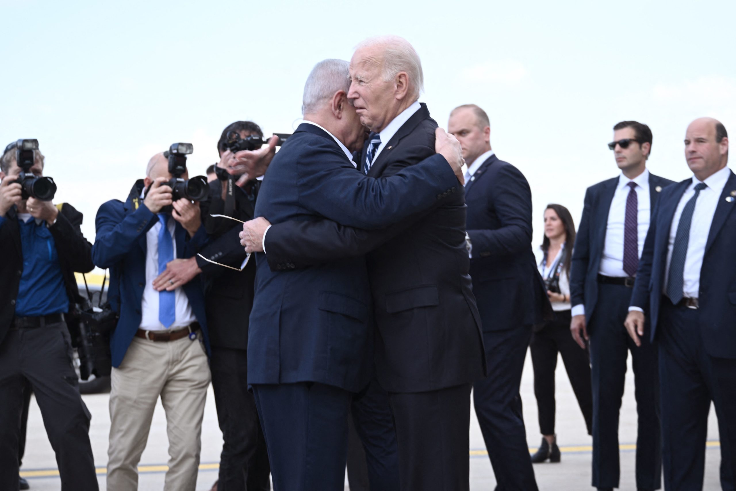 Israel Prime Minister Benjamin Netanyahu (L) hugs US President Joe Biden upon his arrival at Tel Aviv's Ben Gurion airport on October 18, 2023, amid the ongoing battles between Israel and the Palestinian group Hamas. Biden landed in Israel on October 18, on a solidarity visit following Hamas attacks that have led to major Israeli reprisals. (Photo by Brendan SMIALOWSKI / AFP) (Photo by BRENDAN SMIALOWSKI/AFP via Getty Images)