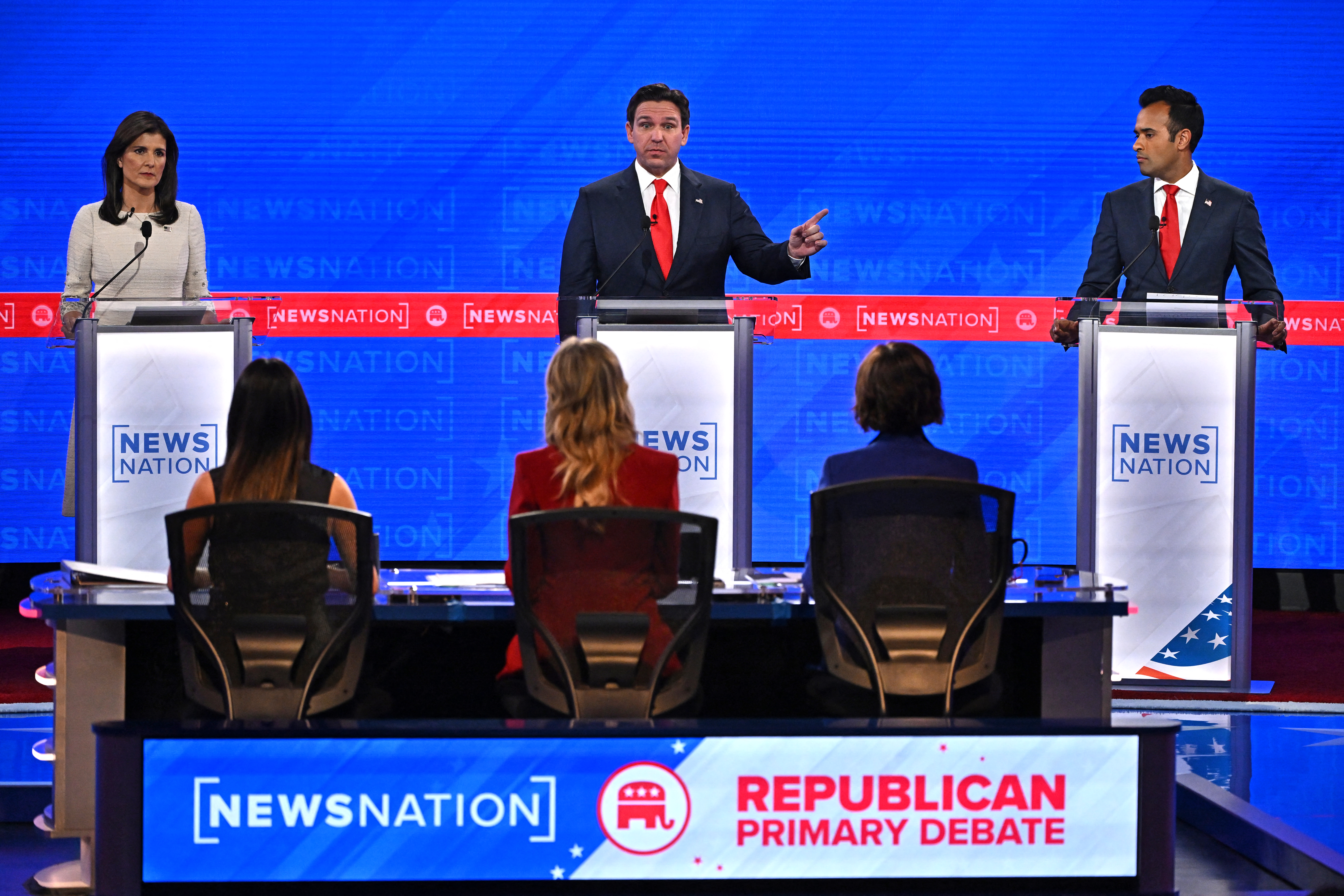 Florida Governor Ron DeSantis (C) speaks, flanked by former Governor from South Carolina and UN ambassador Nikki Haley (L) and entrepreneur Vivek Ramaswamy, during the fourth Republican presidential primary debate at the University of Alabama in Tuscaloosa, Alabama, on December 6, 2023. (Photo by Jim WATSON / AFP) (Photo by JIM WATSON/AFP via Getty Images)
