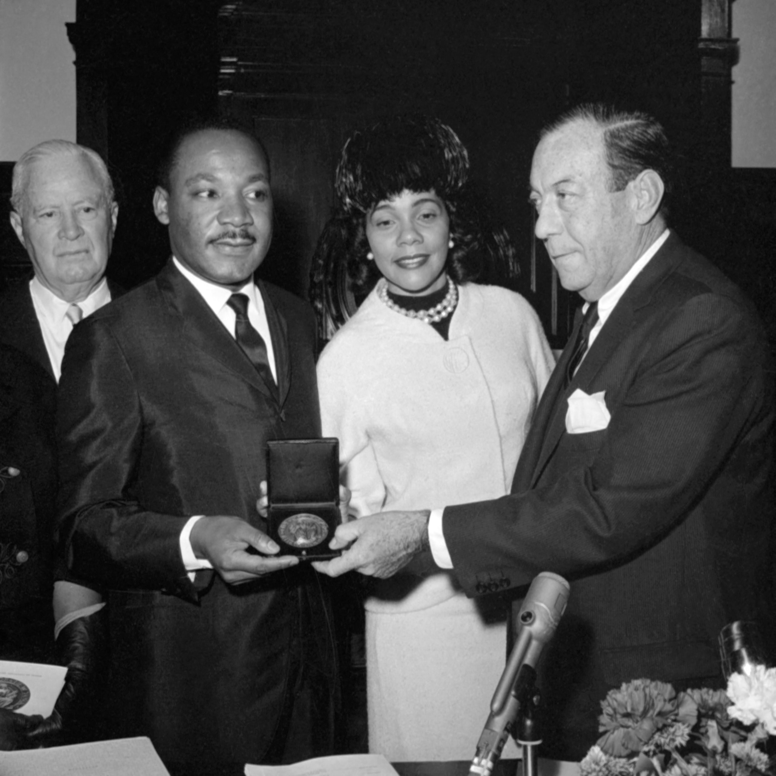US clergyman and leader of the Movement against Racial Segregation Martin Luther King (L) receives the New-York medal of honor from New-York's mayor Robert Wagner (R), as his wife Coretta Scott king (C) looks on, on December 18, 1964 in New-York. Martin Luther King was coming back from Oslo where he received the 1964 Nobel Peace Prize. The only black man whose birthday is a national holiday, Martin Luther King was the leader of the moral fight against racism in America wen he was fatally shot by James Earl Ray 04 April 1968 at the age of 39. (Photo by -/AFP via Getty Images)