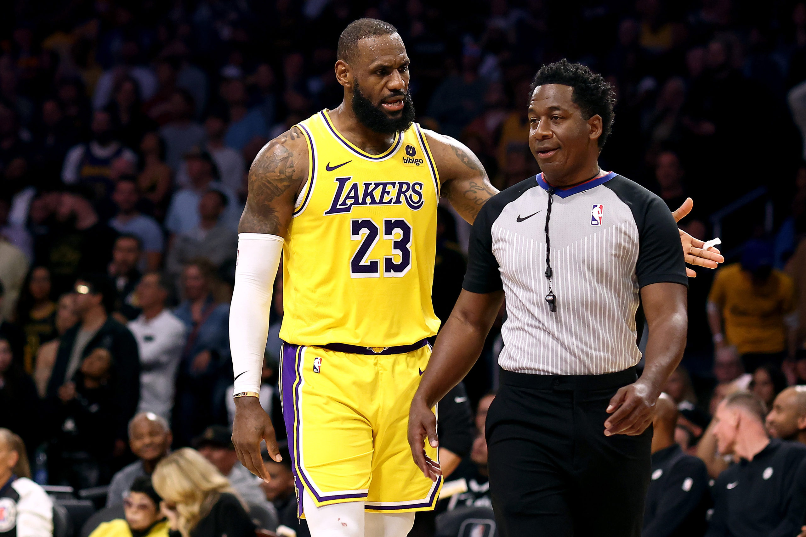 LOS ANGELES, CALIFORNIA - NOVEMBER 01: LeBron James #23 of the Los Angeles Lakers argues with referee Mitchell Ervin #27 during overtime against the Los Angeles Clippers at Crypto.com Arena on November 01, 2023 in Los Angeles, California. Katelyn Mulcahy/Getty Images
