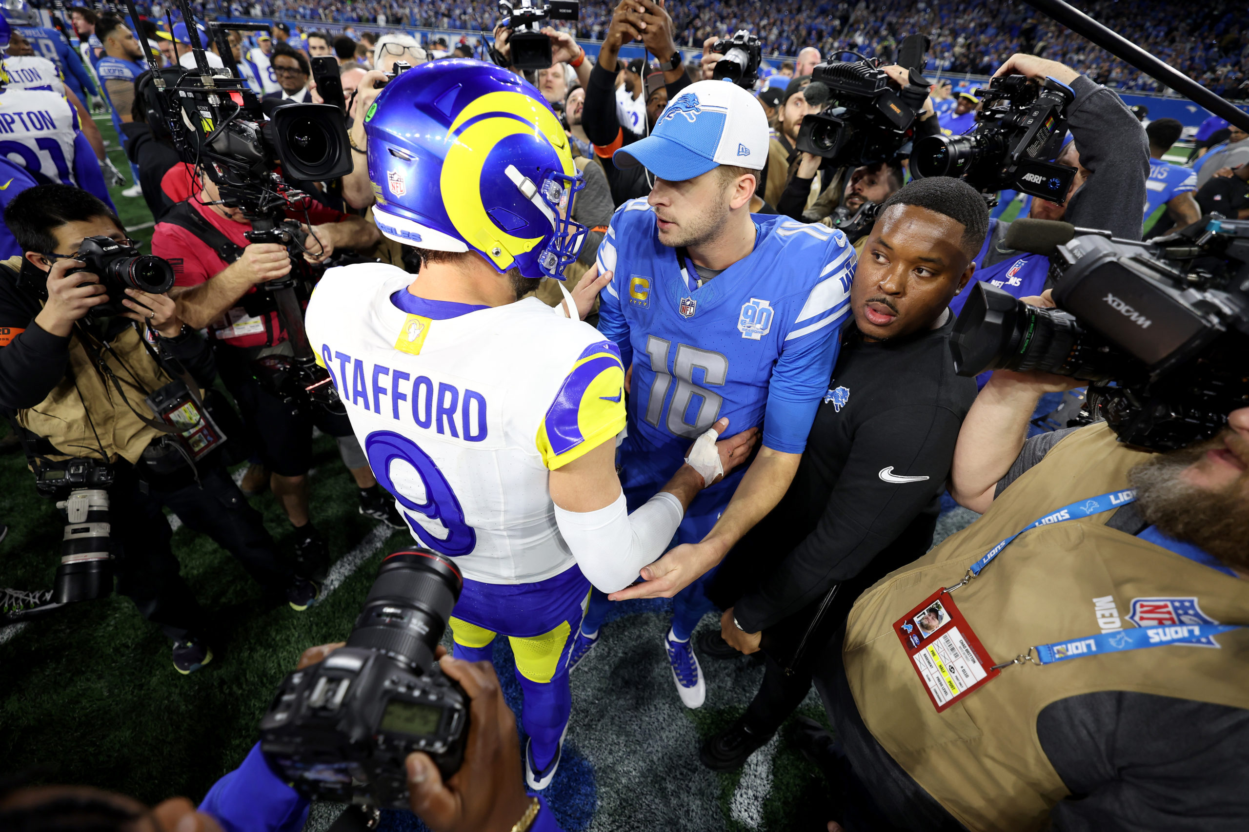 DETROIT, MICHIGAN - JANUARY 14: Matthew Stafford #9 of the Los Angeles Rams talks with Jared Goff #16 of the Detroit Lions following the NFC Wild Card Playoffs at Ford Field on January 14, 2024 in Detroit, Michigan. Detroit defeated Los Angeles 24-23. Gregory Shamus/Getty Images