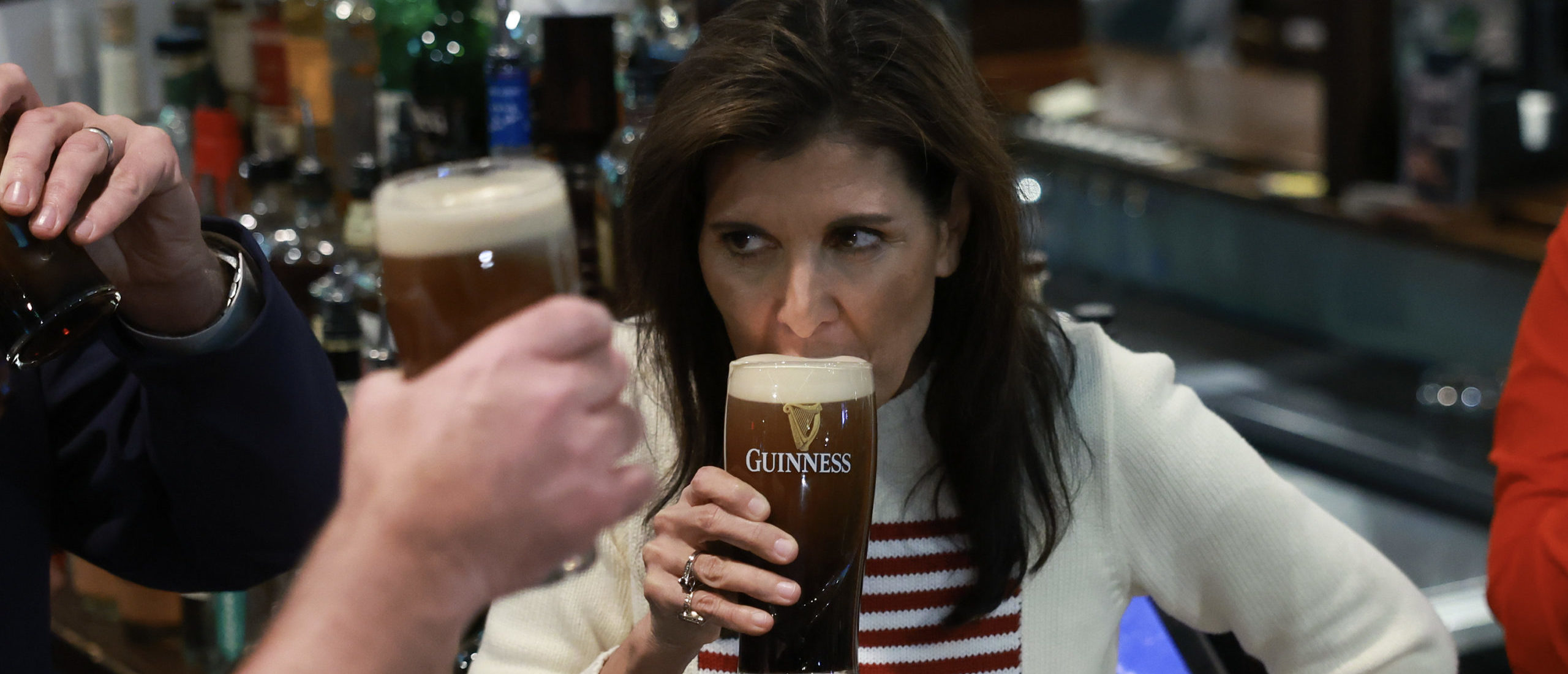 NASHUA, NEW HAMPSHIRE - JANUARY 20: Republican presidential candidate former U.N. Ambassador Nikki Haley enjoys a beer as she visits The Peddler's Daughter on January 20, 2024 in Nashua, New Hampshire. Haley continues to campaign across the state. (Photo by Joe Raedle/Getty Images)