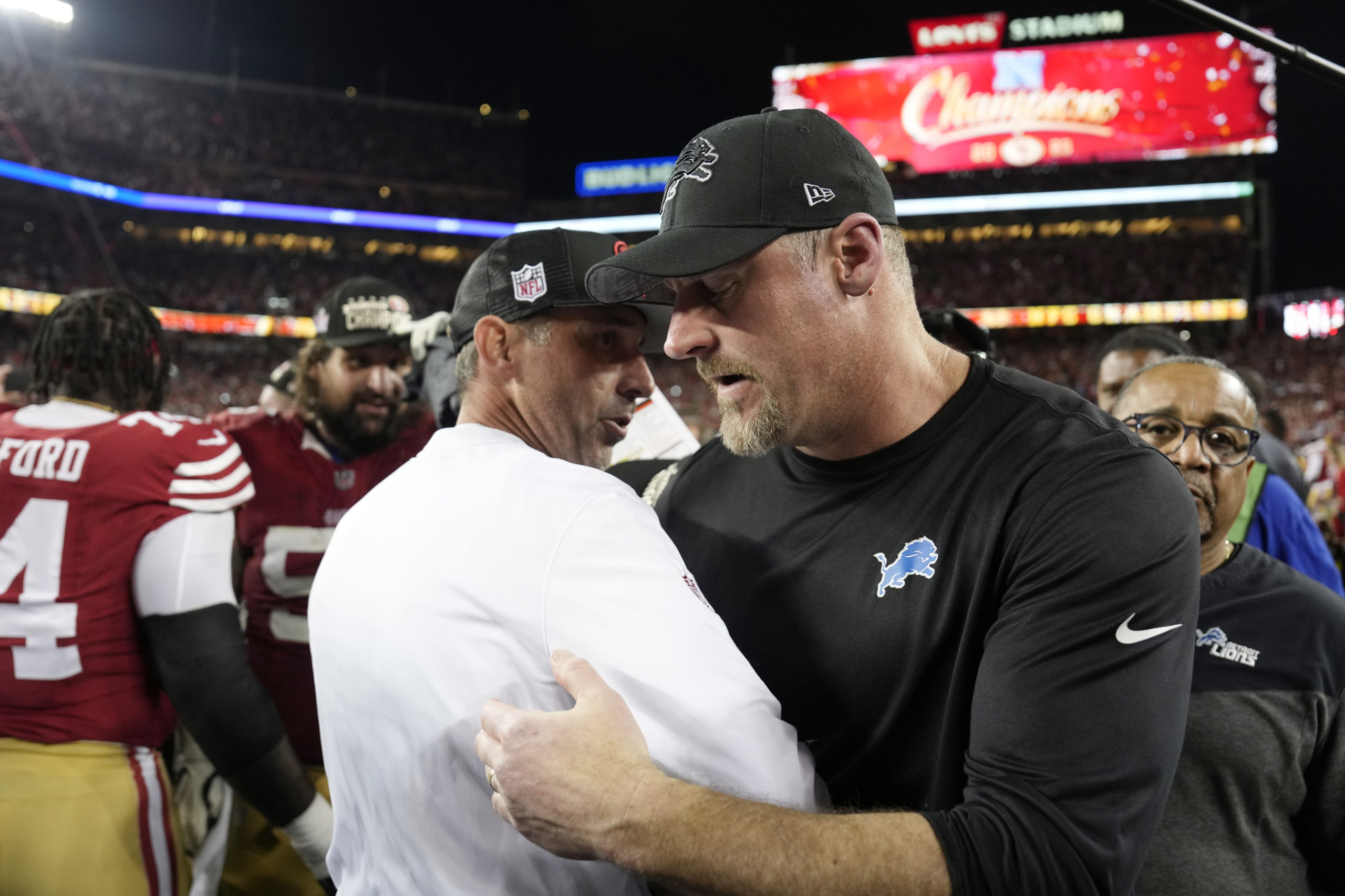 SANTA CLARA, CALIFORNIA - JANUARY 28: Head coach Kyle Shanahan of the San Francisco 49ers hugs Head coach Dan Campbell of the Detroit Lions following the NFC Championship Game at Levi's Stadium on January 28, 2024 in Santa Clara, California. San Francisco defeated Detroit 34-31. Thearon W. Henderson/Getty Images