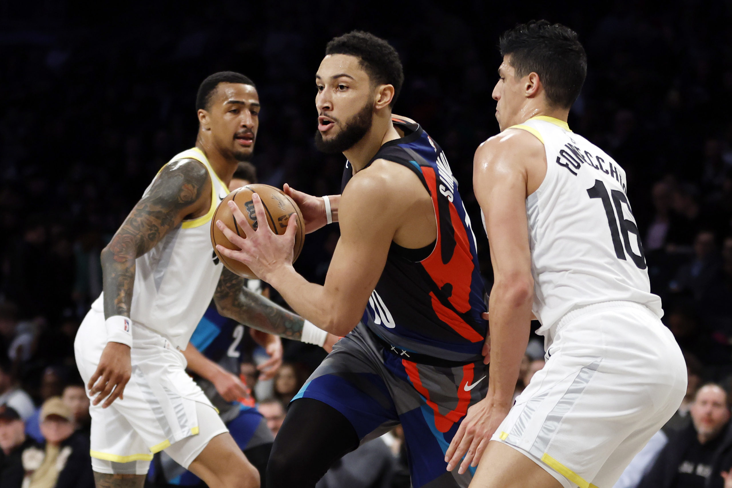 NEW YORK, NEW YORK - JANUARY 29: Ben Simmons #10 of the Brooklyn Nets dribbles against Simone Fontecchio #16 and John Collins #20 of the Utah Jazz during the second half at Barclays Center on January 29, 2024 in the Brooklyn borough of New York City. The Nets won 147-114. Sarah Stier/Getty Images