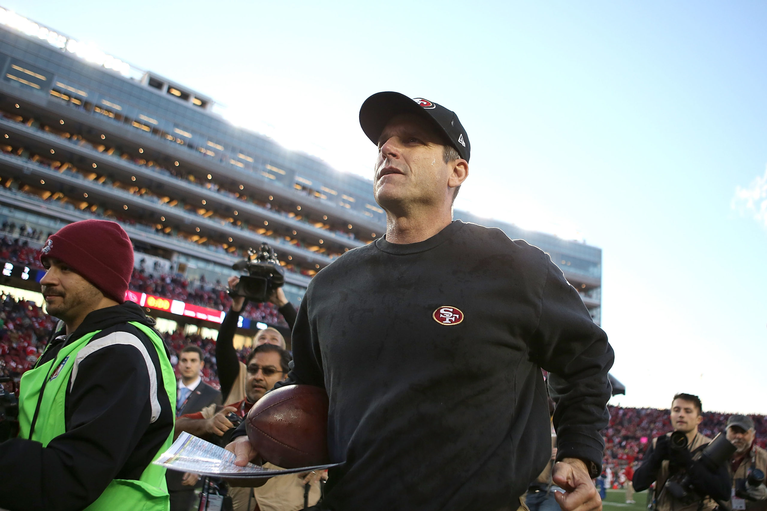 SANTA CLARA, CA - DECEMBER 28: head coach Jim Harbaugh of the San Francisco 49ers leaves the field after their win over the Arizona Cardinals at Levi's Stadium on December 28, 2014 in Santa Clara, California. Don Feria/Getty Images