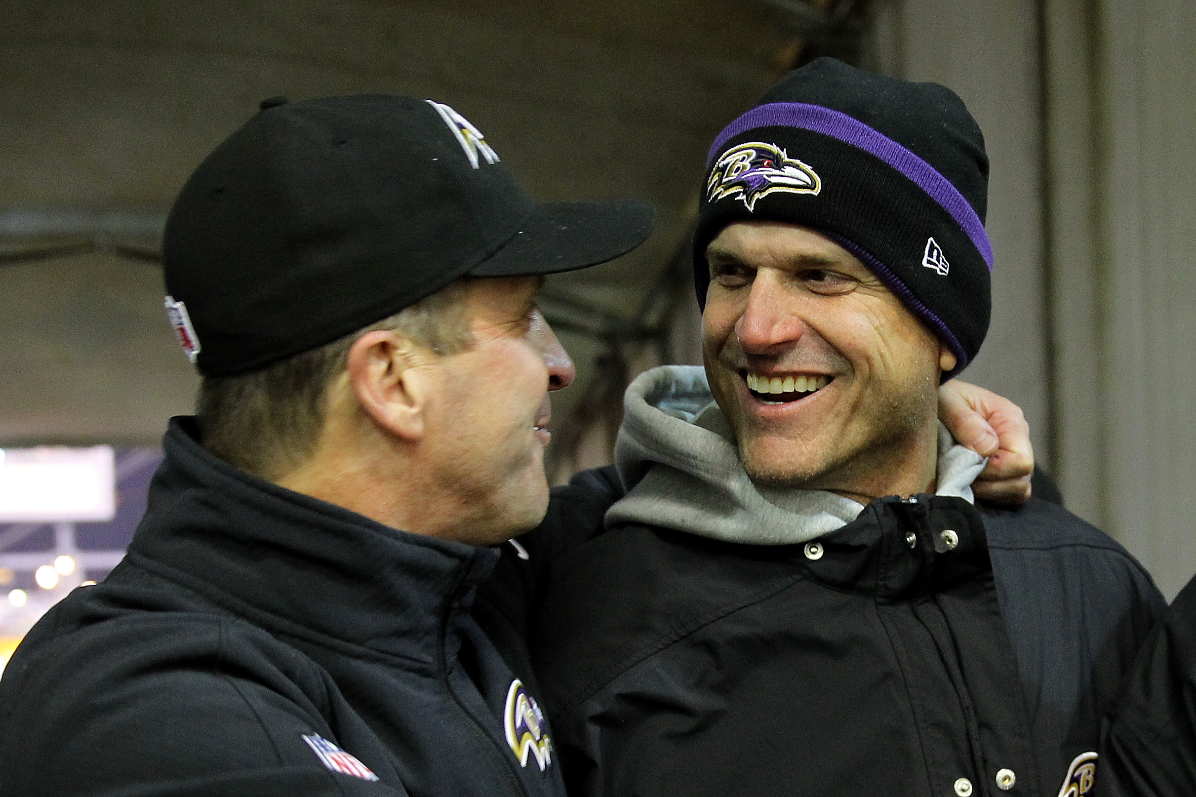 PITTSBURGH, PA - JANUARY 03: Michigan coach Jim Harbaugh (R) celebrates with his brother, head coach John Harbaugh (L) of the Baltimore Ravens after the Ravens defeated the Pittsburgh Steelers 30-17 in their AFC Wild Card game at Heinz Field on January 3, 2015 in Pittsburgh, Pennsylvania. Jamie Squire/Getty Images
