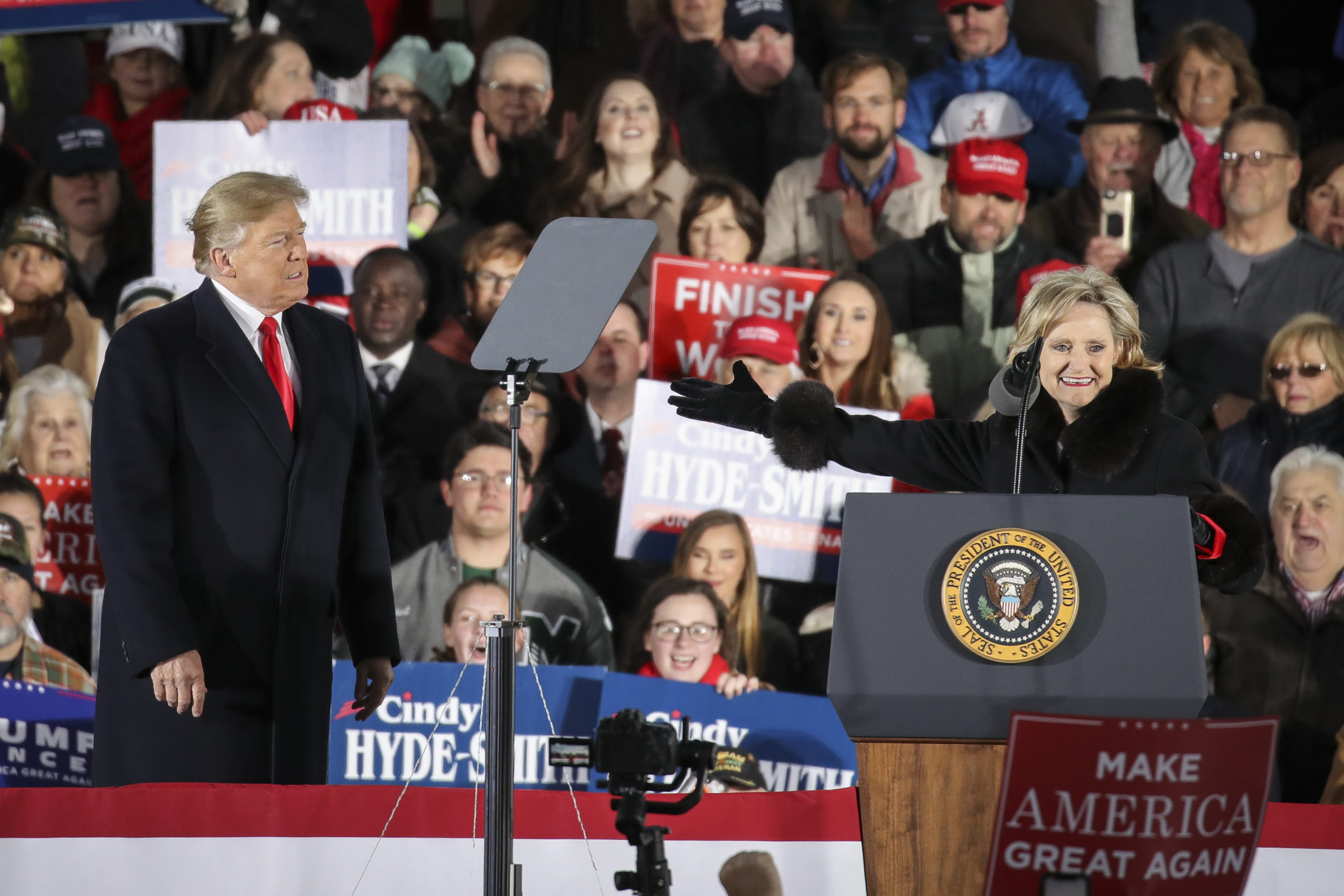 TUPELO, MS - NOVEMBER 26: (L-R) President Donald Trump looks on as Republican candidate for U.S. Senate Cindy Hyde-Smith thanks him during a rally at the Tupelo Regional Airport, November 26, 2018 in Tupelo, Mississippi. President Trump is holding two rallies on Monday in Mississippi, in support of Republican candidate for U.S. Senate Cindy Hyde-Smith. Hyde-Smith faces off against Democratic candidate Mike Espy in a runoff election on Tuesday. (Photo by Drew Angerer/Getty Images)