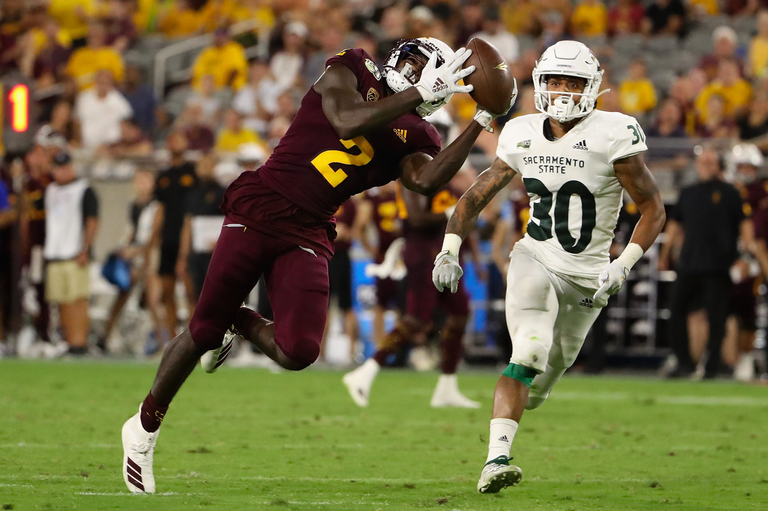 TEMPE, ARIZONA - SEPTEMBER 06: Wide receiver Brandon Aiyuk #2 of the Arizona State Sun Devils catches a 52 yard reception ahead of defensive back Allen Perryman #30 of the Sacramento State Hornets during the second half of the NCAAF game at Sun Devil Stadium on September 06, 2019 in Tempe, Arizona. Christian Petersen/Getty Images