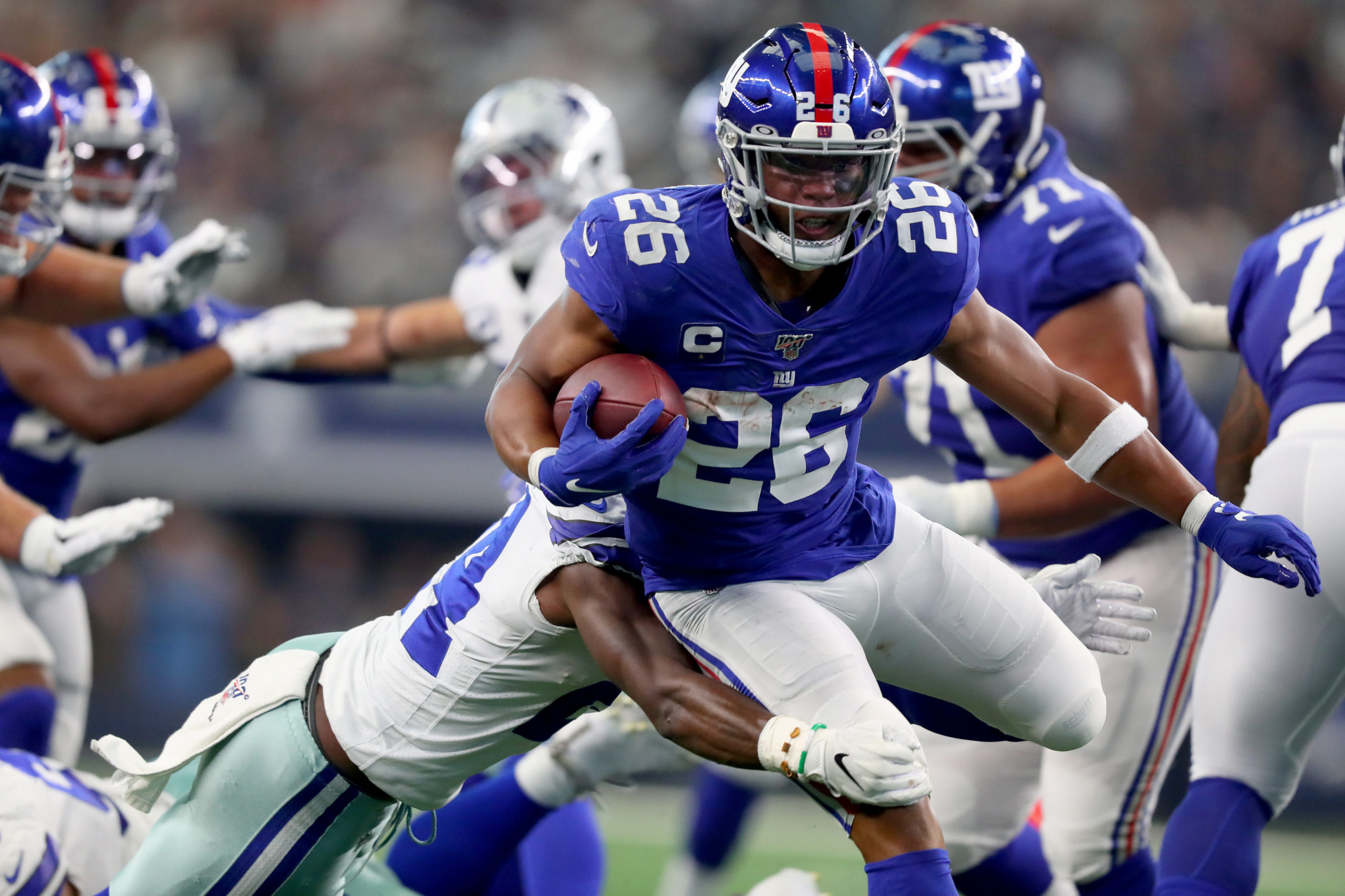 ARLINGTON, TEXAS - SEPTEMBER 08: Saquon Barkley #26 of the New York Giants carries the ball against Chidobe Awuzie #24 of the Dallas Cowboys in the third quarter at AT&T Stadium on September 08, 2019 in Arlington, Texas. Tom Pennington/Getty Images