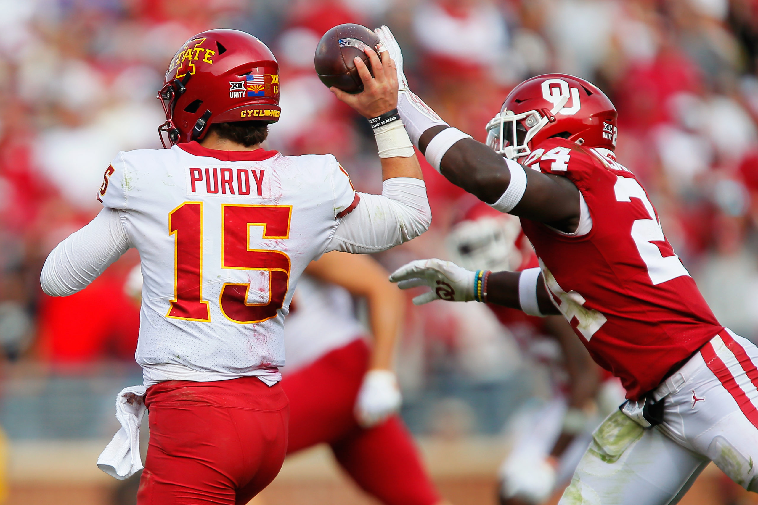 NORMAN, OK - NOVEMBER 20: Linebacker Brian Asamoah #24 of the Oklahoma Sooners knocks the ball out of the hands of quarterback Brock Purdy #15 of the Iowa State Cyclones for a fumble recovered by Purdy in the second quarter at Gaylord Family Oklahoma Memorial Stadium on November 20, 2021 in Norman, Oklahoma. Brian Bahr/Getty Images