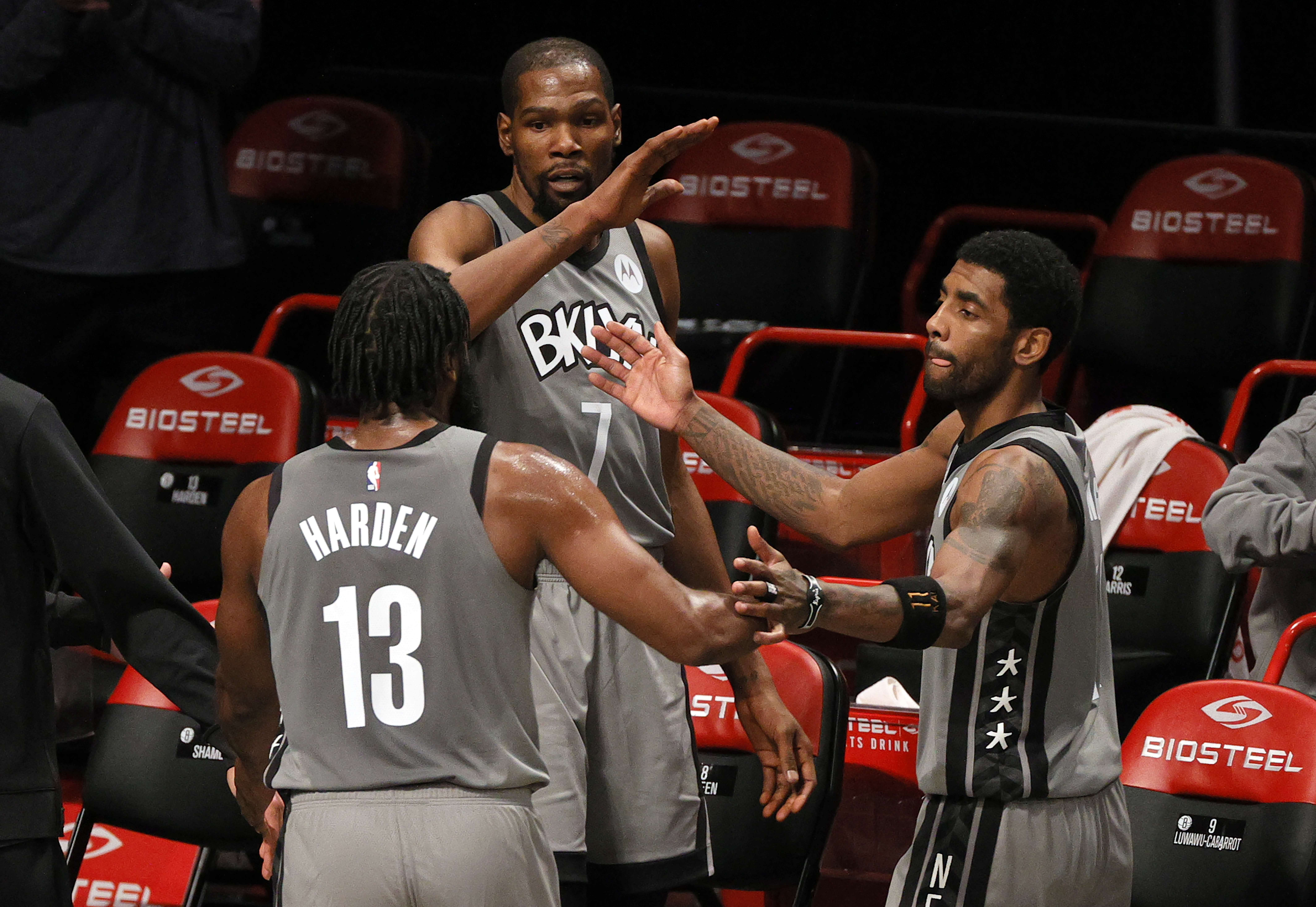 NEW YORK, NEW YORK - JANUARY 25: James Harden #13, Kevin Durant #7, and Kyrie Irving #11 of the Brooklyn Nets high-five after coming off the court during the second half against the Miami Heat at Barclays Center on January 25, 2021 in the Brooklyn borough of New York City. The Nets won 98-85. Sarah Stier/Getty Images