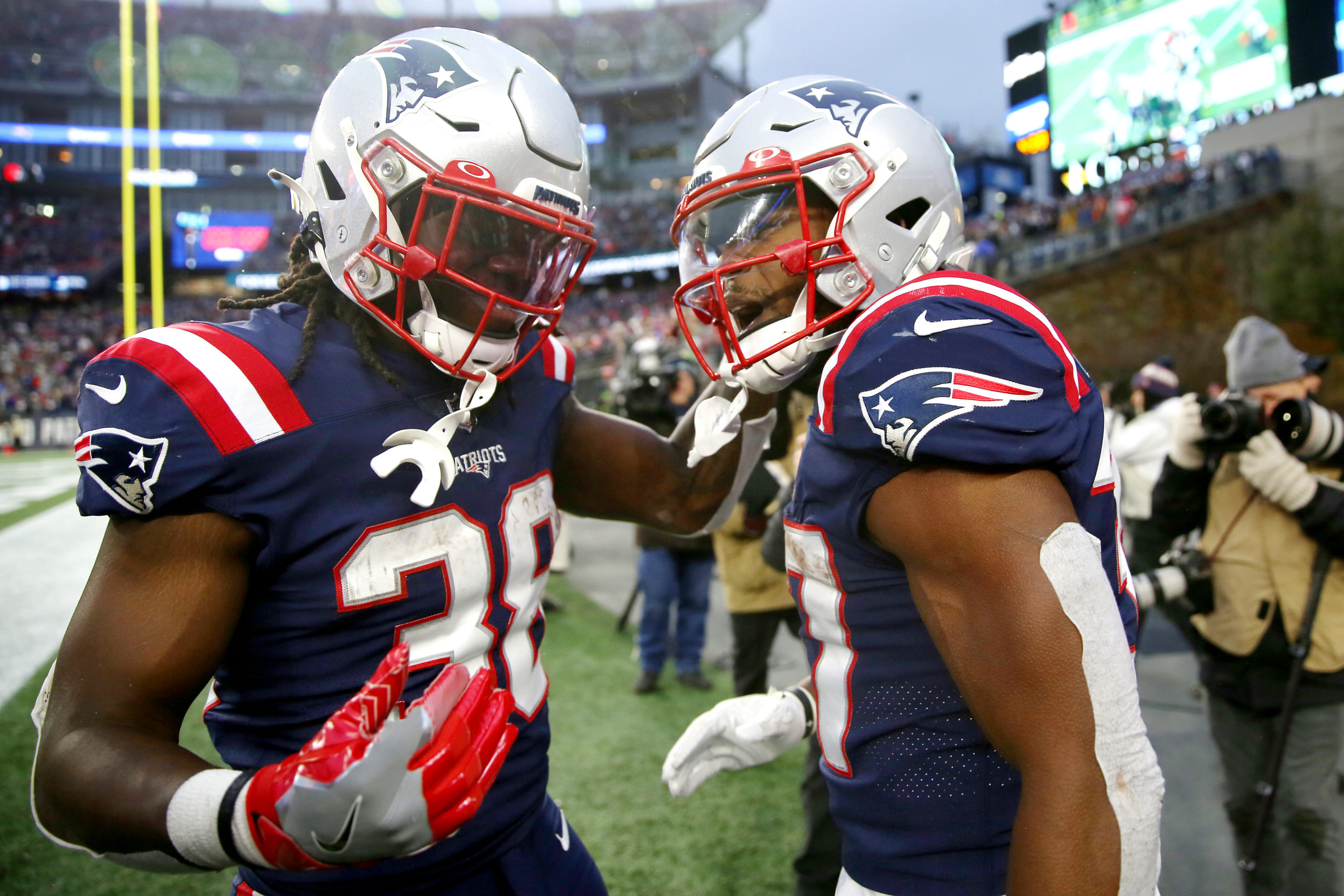 FOXBOROUGH, MASSACHUSETTS - NOVEMBER 28: Damien Harris #37 of the New England Patriots celebrates with Rhamondre Stevenson #38 after scoring a rushing touchdown against the Tennessee Titans in the fourth quarter at Gillette Stadium on November 28, 2021 in Foxborough, Massachusetts. Adam Glanzman/Getty Images