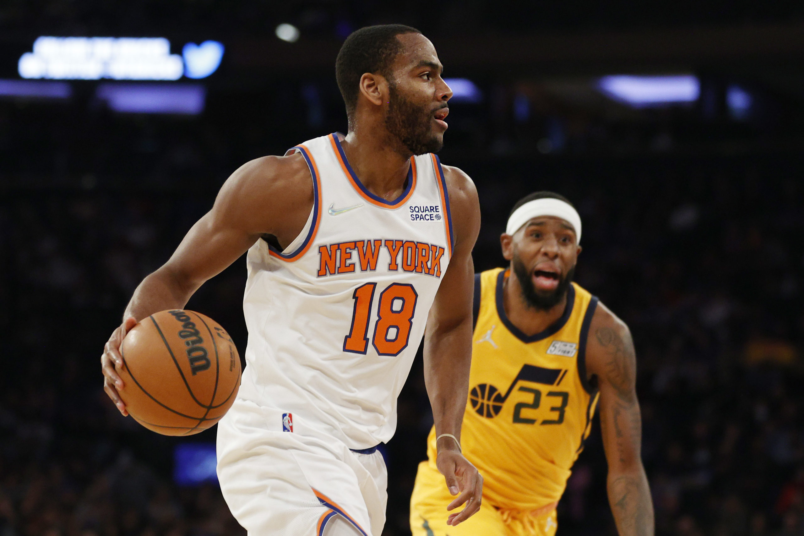 NEW YORK, NEW YORK - MARCH 20: Alec Burks #18 of the New York Knicks dribbles as Royce O'Neale #23 of the Utah Jazz defends during the first half at Madison Square Garden on March 20, 2022 in New York City. Sarah Stier/Getty Images