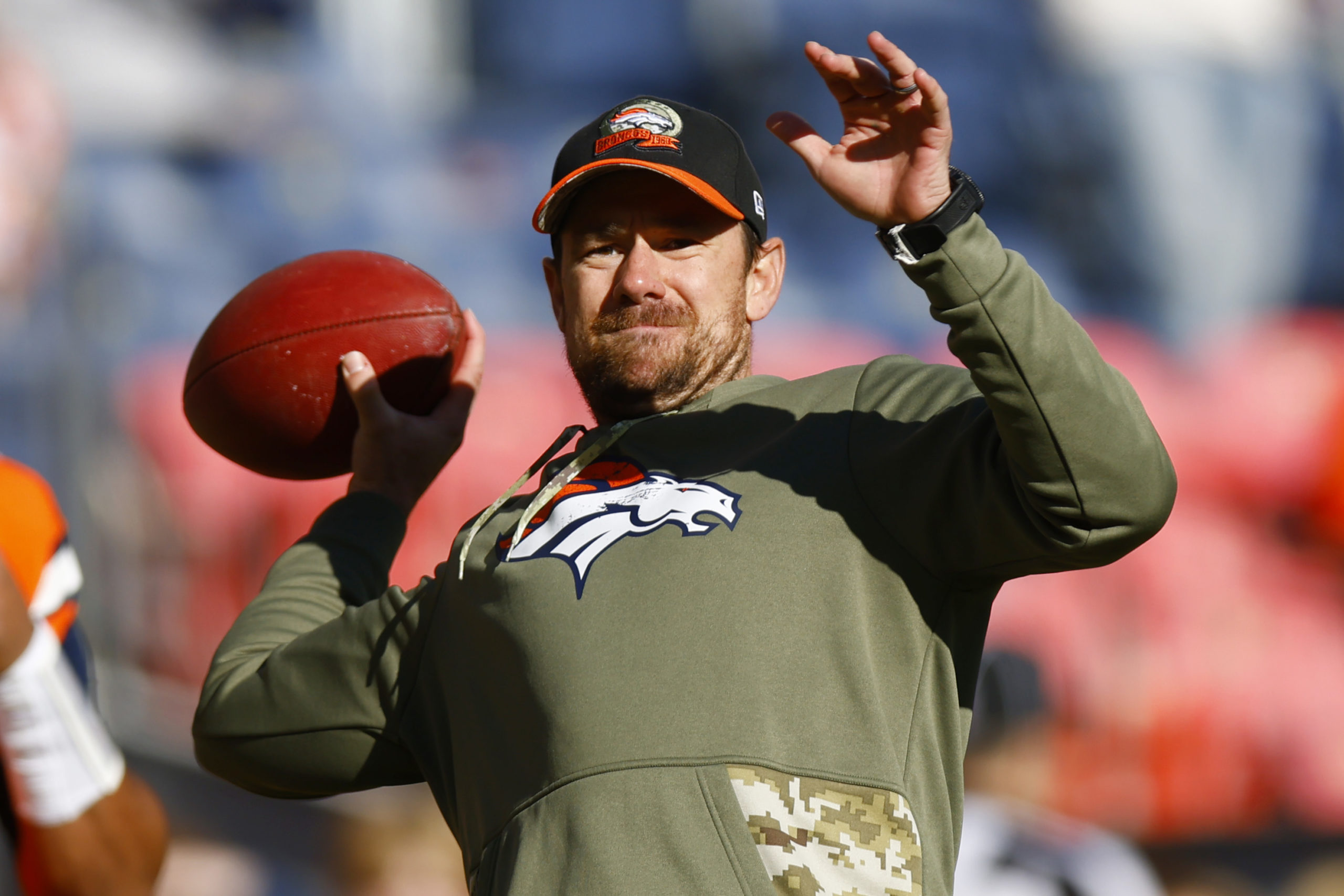 DENVER, COLORADO - NOVEMBER 20: Klint Kubiak quarterbacks coach for the Denver Broncos throws a pass during warmups prior to a game against the Las Vegas Raiders at Empower Field At Mile High on November 20, 2022 in Denver, Colorado. Justin Edmonds/Getty Images