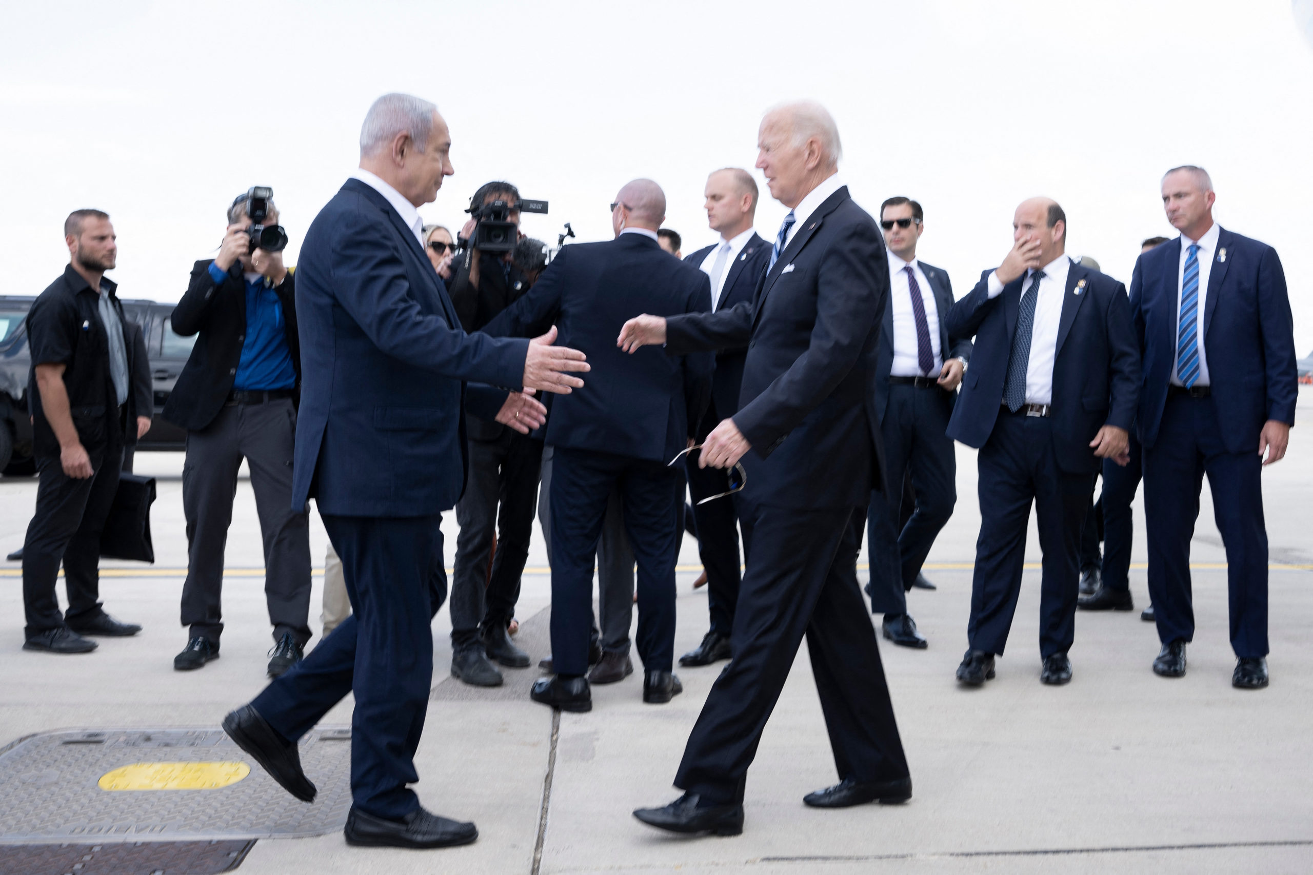 Israel Prime Minister Benjamin Netanyahu (L) greets US President Joe Biden upon his arrival at Tel Aviv's Ben Gurion airport (Photo by BRENDAN SMIALOWSKI/AFP via Getty Images)