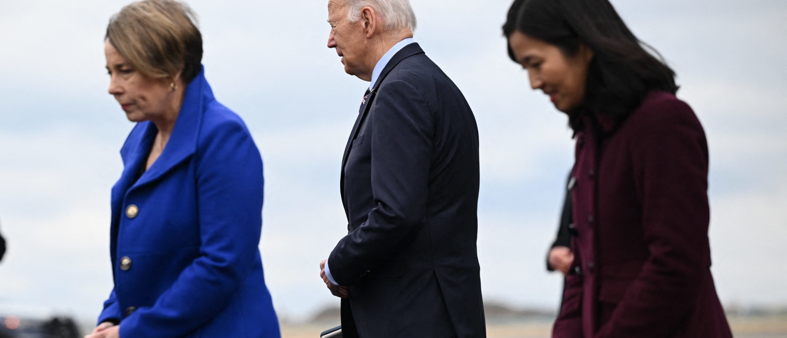 US President Joe Biden is greeted by Massachusetts Governor Maura Healy (L) and Boston Mayor Michelle Wu, as he disembarks Air Force One at Boston Logan International Airport in Boston, Massachusetts, on December 5, 2023. (Photo by MANDEL NGAN/AFP via Getty Images)