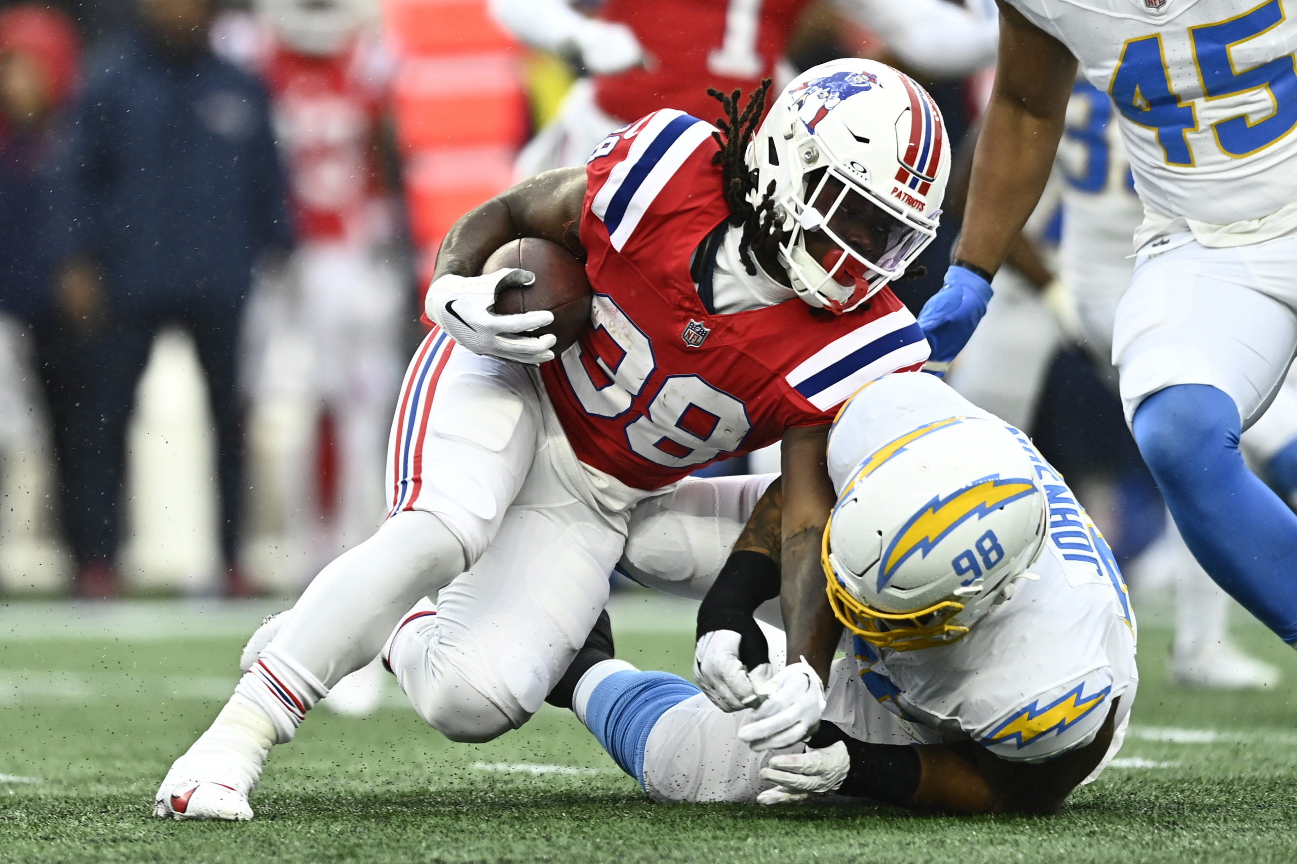 FOXBOROUGH, MASSACHUSETTS - DECEMBER 03: Rhamondre Stevenson #38 carries the ball during the game against the Los Angeles Chargers at Gillette Stadium on December 03, 2023 in Foxborough, Massachusetts. Billie Weiss/Getty Images