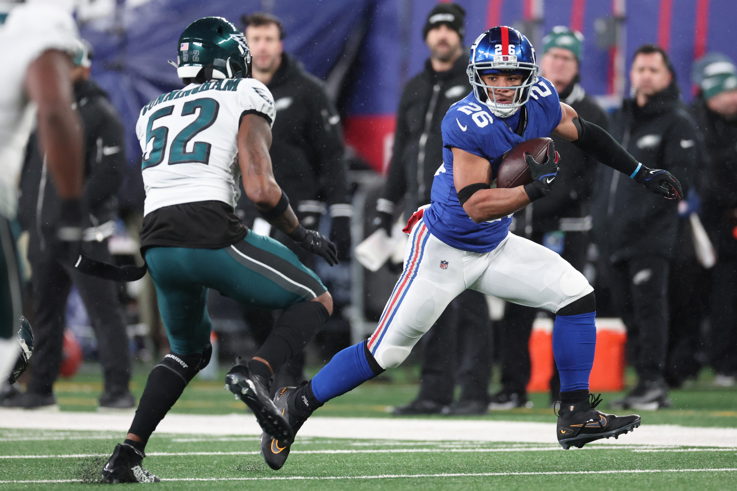 EAST RUTHERFORD, NEW JERSEY - JANUARY 07: Saquon Barkley #26 of the New York Giants runs the ball while defended by Zach Cunningham #52 of the Philadelphia Eagles during the first half at MetLife Stadium on January 07, 2024 in East Rutherford, New Jersey. Al Bello/Getty Images