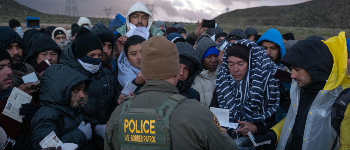 Asylum seekers rush to be processed by border patrol agents at an improvised camp near the US-Mexico border in eastern Jacumba, California, on February 2, 2024. (Photo by Guillermo Arias / AFP) (Photo by GUILLERMO ARIAS/AFP via Getty Images)