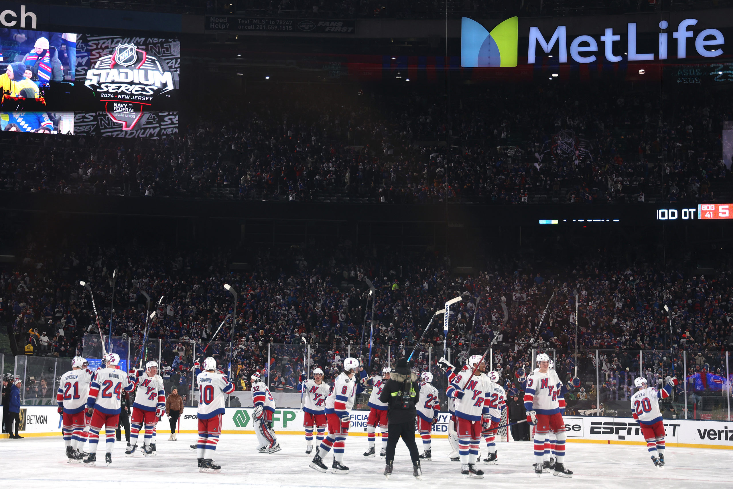 EAST RUTHERFORD, NEW JERSEY - FEBRUARY 18: The New York Rangers celebrate their 6-5 overtime win against the New York Islanders during the 2024 Navy Federal Credit Union Stadium Series at MetLife Stadium on February 18, 2024 in East Rutherford, New Jersey. Al Bello/Getty Images
