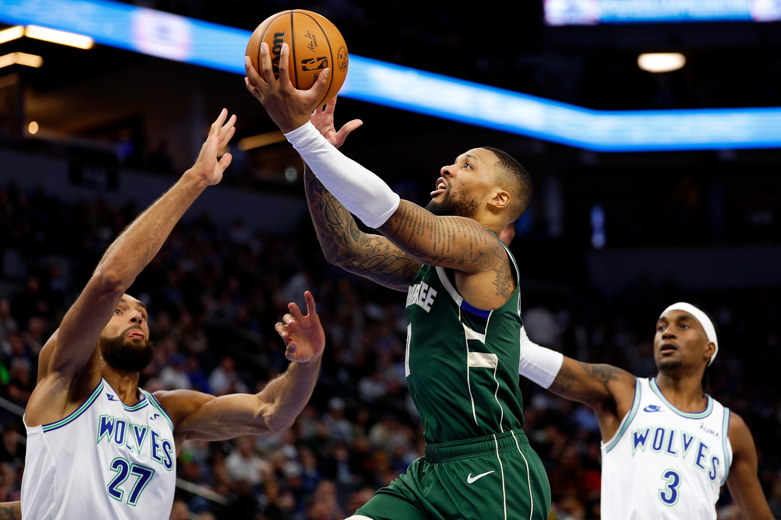 MINNEAPOLIS, MINNESOTA - FEBRUARY 23: Damian Lillard #0 of the Milwaukee Bucks goes up for a shot against Rudy Gobert #27 of the Minnesota Timberwolves in the third quarter at Target Center on February 23, 2024 in Minneapolis, Minnesota. The Bucks defeated the Timberwolves 112-107. David Berding/Getty Images