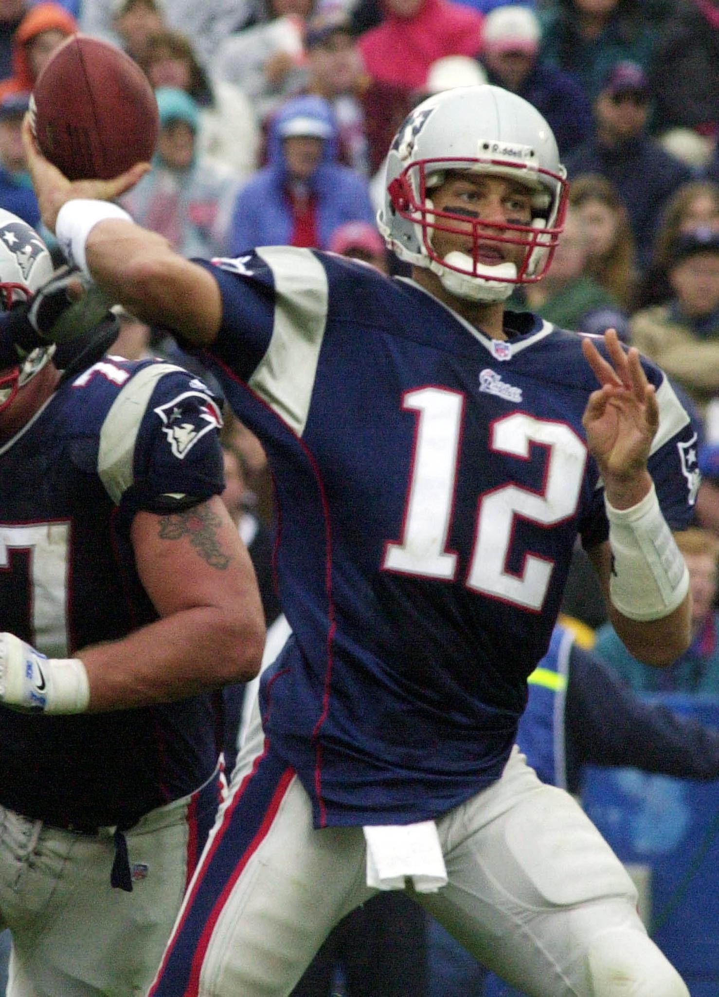FOXBORO, UNITED STATES: The New England Patriots' quarterback Tom Brady passes against the San Diego Chargers in the forth quarter 14 October 2001 in Foxboro Stadium in Foxboro, Massachusetts. The Patriots won 29-26 in over time. JOHN MOTTERN/AFP via Getty Images