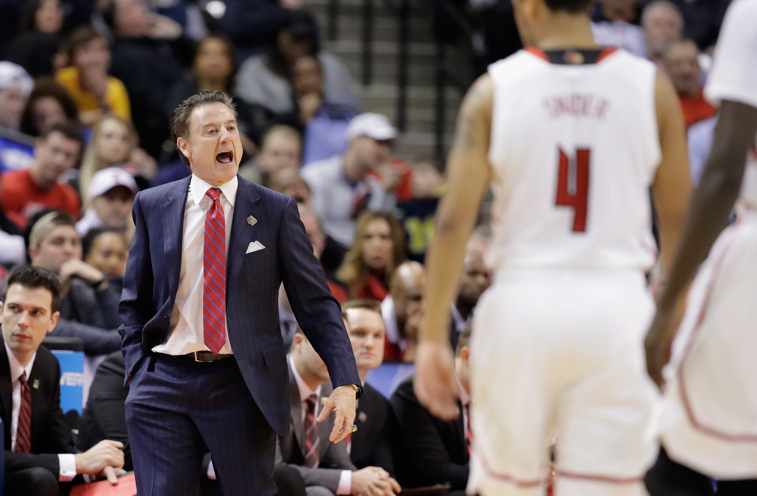 INDIANAPOLIS, IN - MARCH 19: Head coach Rick Pitino of the Louisville Cardinals reacts as Quentin Snider #4 looks on against the Michigan Wolverines in the first half during the second round of the 2017 NCAA Men's Basketball Tournament at the Bankers Life Fieldhouse on March 19, 2017 in Indianapolis, Indiana. Andy Lyons/Getty Images