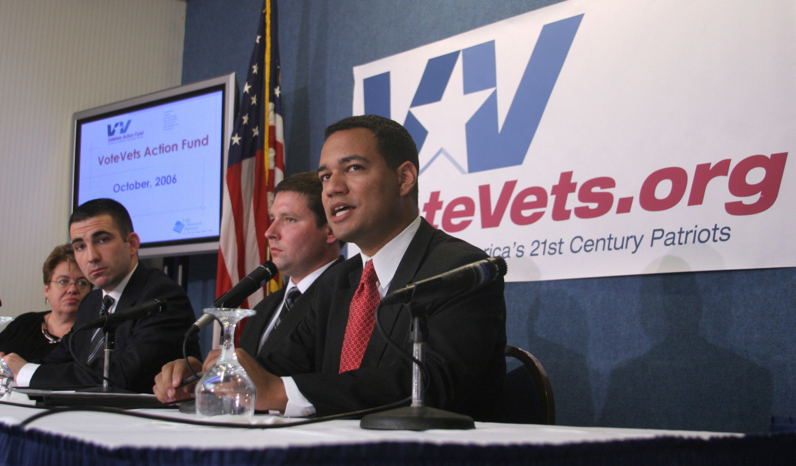 Washington, UNITED STATES: VoteVets.org co-founder and president Jeremy Broussard speaks during a press conference by the veterans advocacy group in Washington 04 October 2006 as Lake Research Partners president Celinda Lake (L), Jon Soltz (2nd L), co-founder and chairman of VoteVets. org Action Fund and VoteVets.org senior advisor Sam Schultz (2nd R) look on. US troops serving in Iraq and Afghanistan lack proper equipment, are overstretched and face serious health problems upon their return home, according to a poll released by the group. AFP PHOTO/Nicholas KAMM (Photo credit should read NICHOLAS KAMM/AFP via Getty Images)