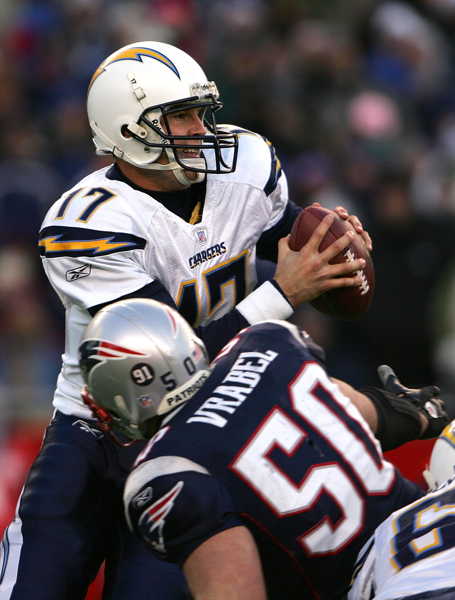 FOXBORO, MA - JANUARY 20: Philip Rivers #17 of the San Diego Chargers looks to pass under pressure from Mike Vrabel #50 of the New England Patriots during the AFC Championship Game on January 20, 2008 at Gillette Stadium in Foxboro, Massachusetts. Chris McGrath/Getty Images