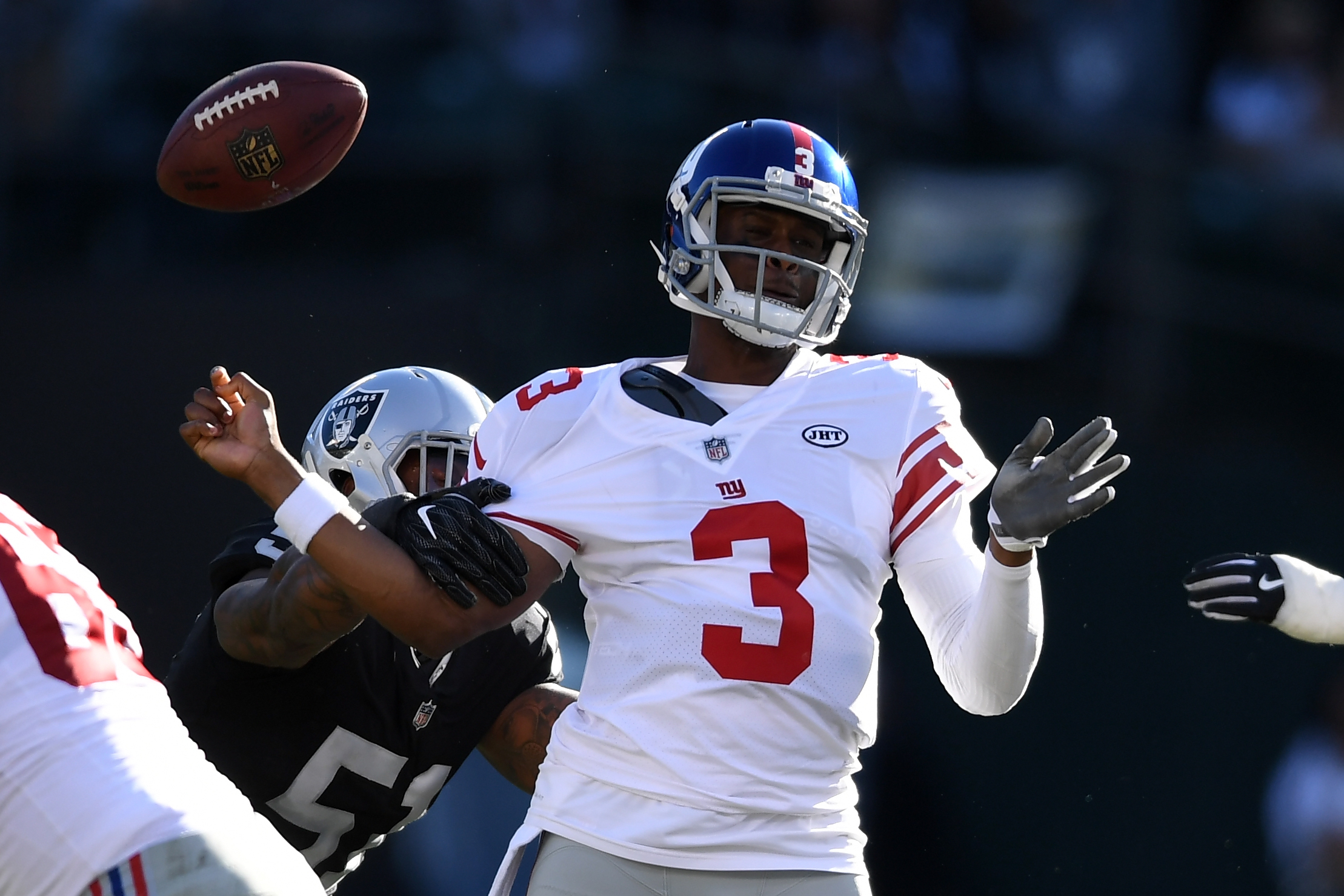 OAKLAND, CA - DECEMBER 03: Geno Smith #3 of the New York Giants is stripped of the ball by Bruce Irvin #51 of the Oakland Raiders during their NFL game at Oakland-Alameda County Coliseum on December 3, 2017 in Oakland, California. Thearon W. Henderson/Getty Images