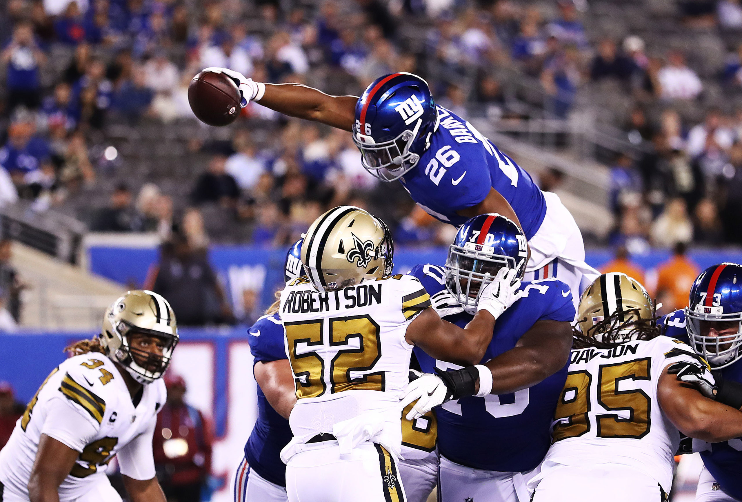 EAST RUTHERFORD, NEW JERSEY - SEPTEMBER 30: Saquon Barkley #26 of the New York Giants scores a touchdown in the fourth Quarter against the New Orleans Saints during their game at MetLife Stadium on September 30, 2018 in East Rutherford, New Jersey. Al Bello/Getty Images