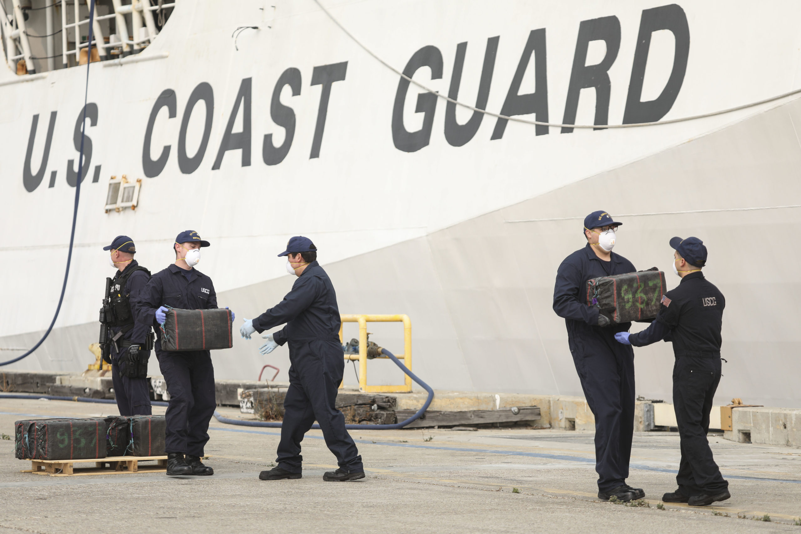 US Coast Guard personel unload bundles of seized drugs in front of the Cutter Bertholf on September 10, 2020 in San Diego, California. (Photo by SANDY HUFFAKER/AFP via Getty Images)