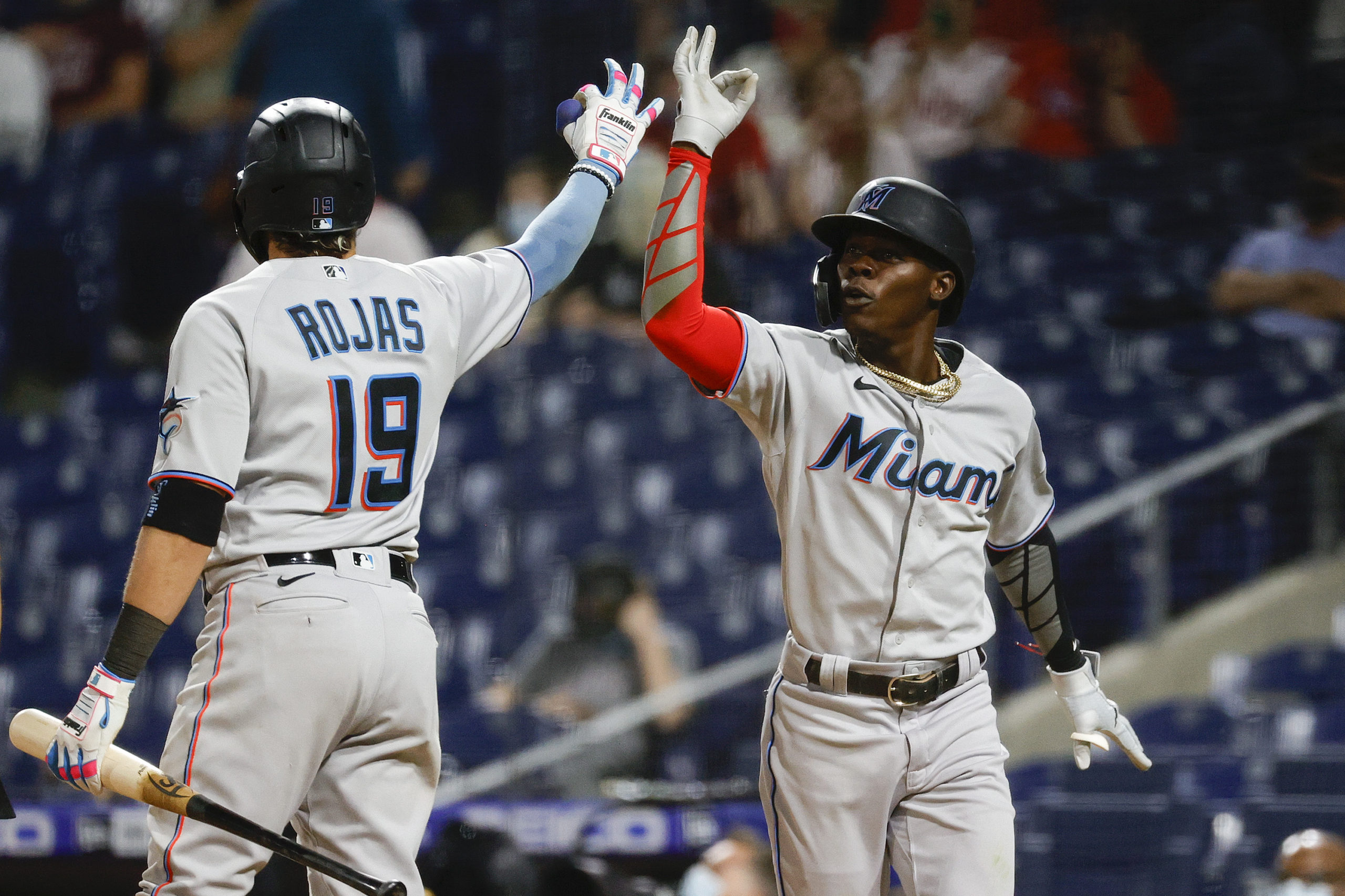PHILADELPHIA, PENNSYLVANIA - MAY 18: Jazz Chisholm Jr. #2 (R) of the Miami Marlins celebrates with teammate Miguel Rojas #19 after hitting a two-run home run during the eighth inning against the Philadelphia Phillies at Citizens Bank Park on May 18, 2021 in Philadelphia, Pennsylvania. Tim Nwachukwu/Getty Images
