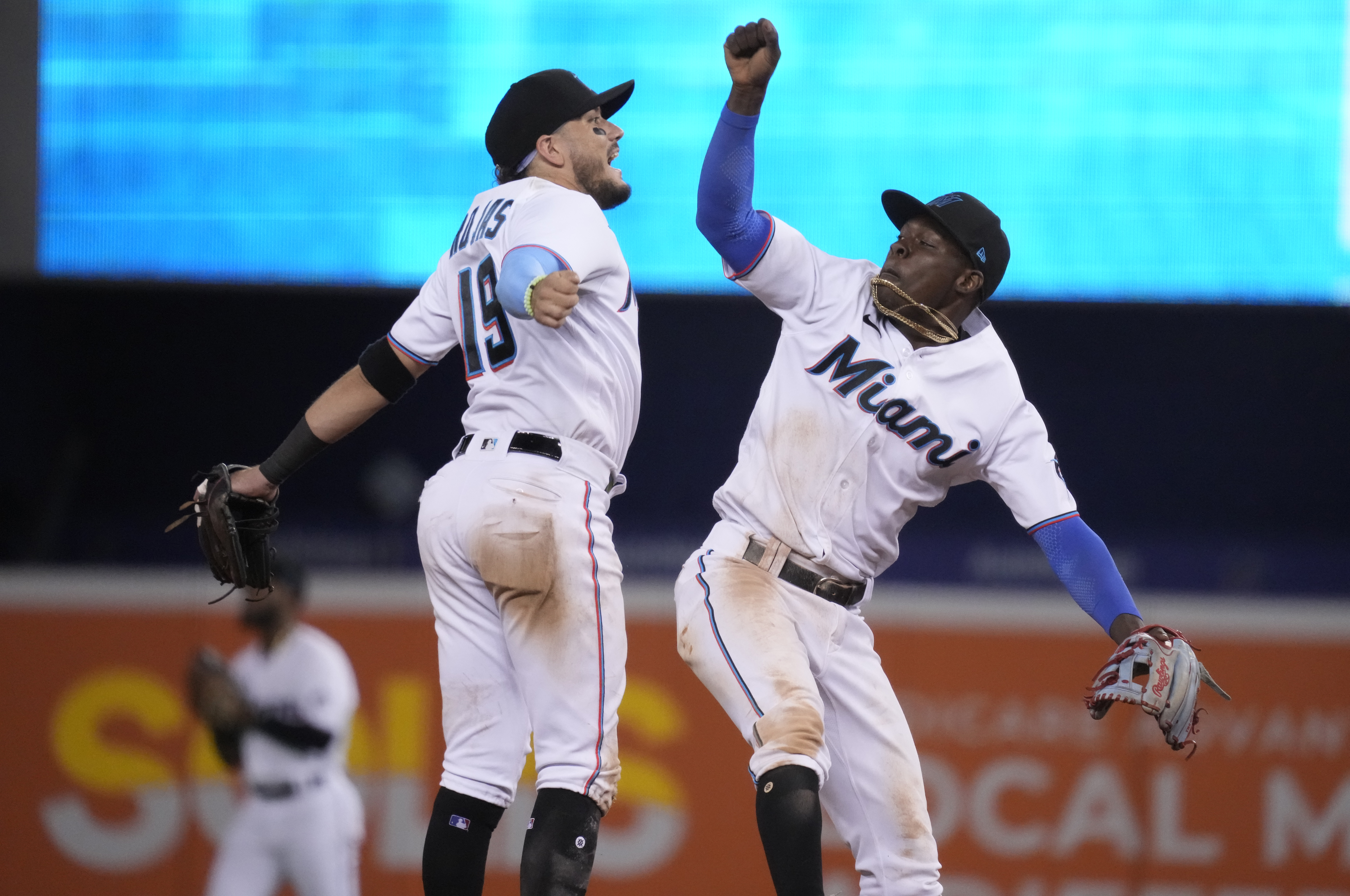 MIAMI, FLORIDA - AUGUST 02: Jazz Chisholm Jr. #2 and Miguel Rojas #19 of the Miami Marlins celebrate after defeating the New York Mets by score of 6-3 at loanDepot park on August 02, 2021 in Miami, Florida. Mark Brown/Getty Images