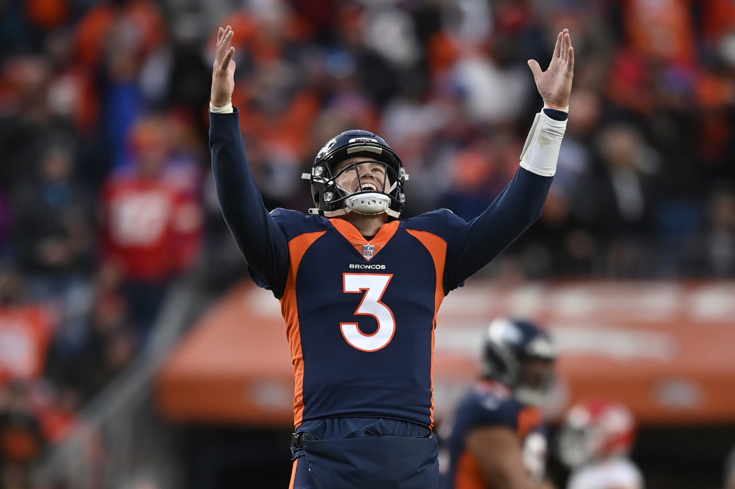 DENVER, COLORADO - JANUARY 08: Drew Lock #3 of the Denver Broncos reacts after Melvin Gordon #25 rushes for a touchdown during the fourth quarter against the Kansas City Chiefs at Empower Field At Mile High on January 08, 2022 in Denver, Colorado. Dustin Bradford/Getty Images