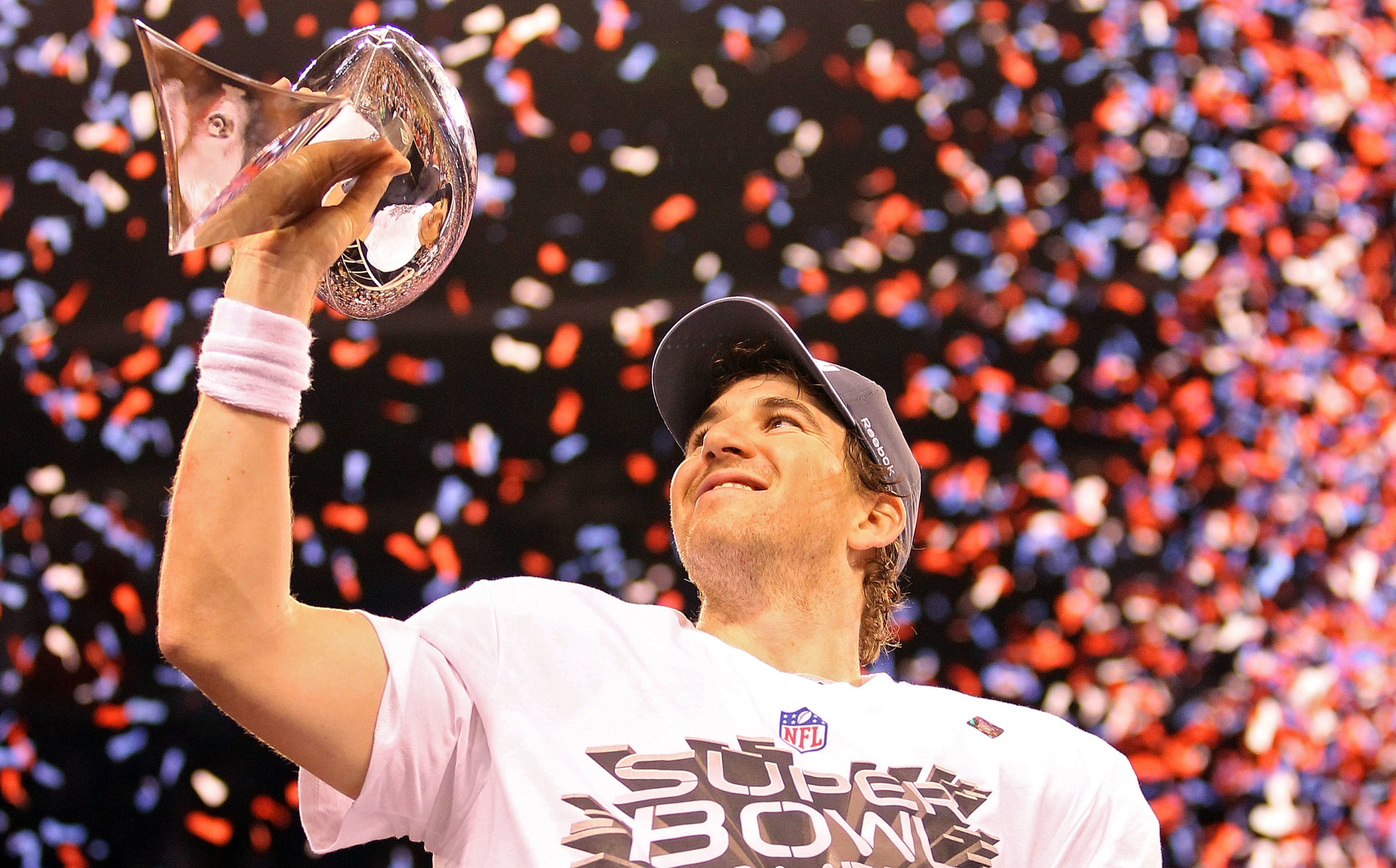 INDIANAPOLIS, IN - FEBRUARY 05: Quarterback Eli Manning #10 of the New York Giants poses with the Vince Lombardi Trophy after the Giants defeated the Patriots by a score of 21-17 in Super Bowl XLVI at Lucas Oil Stadium on February 5, 2012 in Indianapolis, Indiana. Ezra Shaw/Getty Images