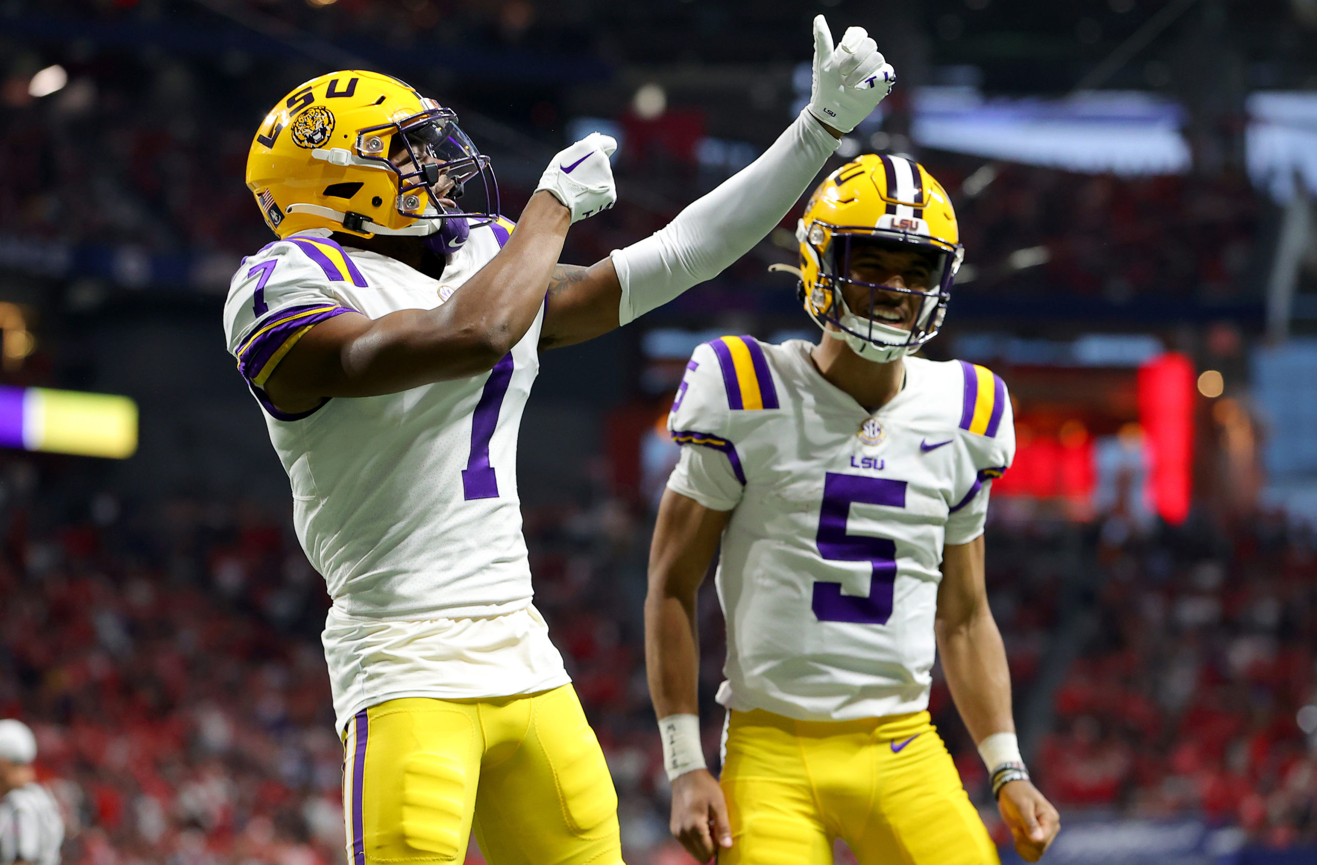 ATLANTA, GEORGIA - DECEMBER 03: Kayshon Boutte #7 of the LSU Tigers celebrates with Jayden Daniels #5 after scoring a 53 yard touchdown against the Georgia Bulldogs during the first quarter in the SEC Championship game at Mercedes-Benz Stadium on December 03, 2022 in Atlanta, Georgia. Kevin C. Cox/Getty Images