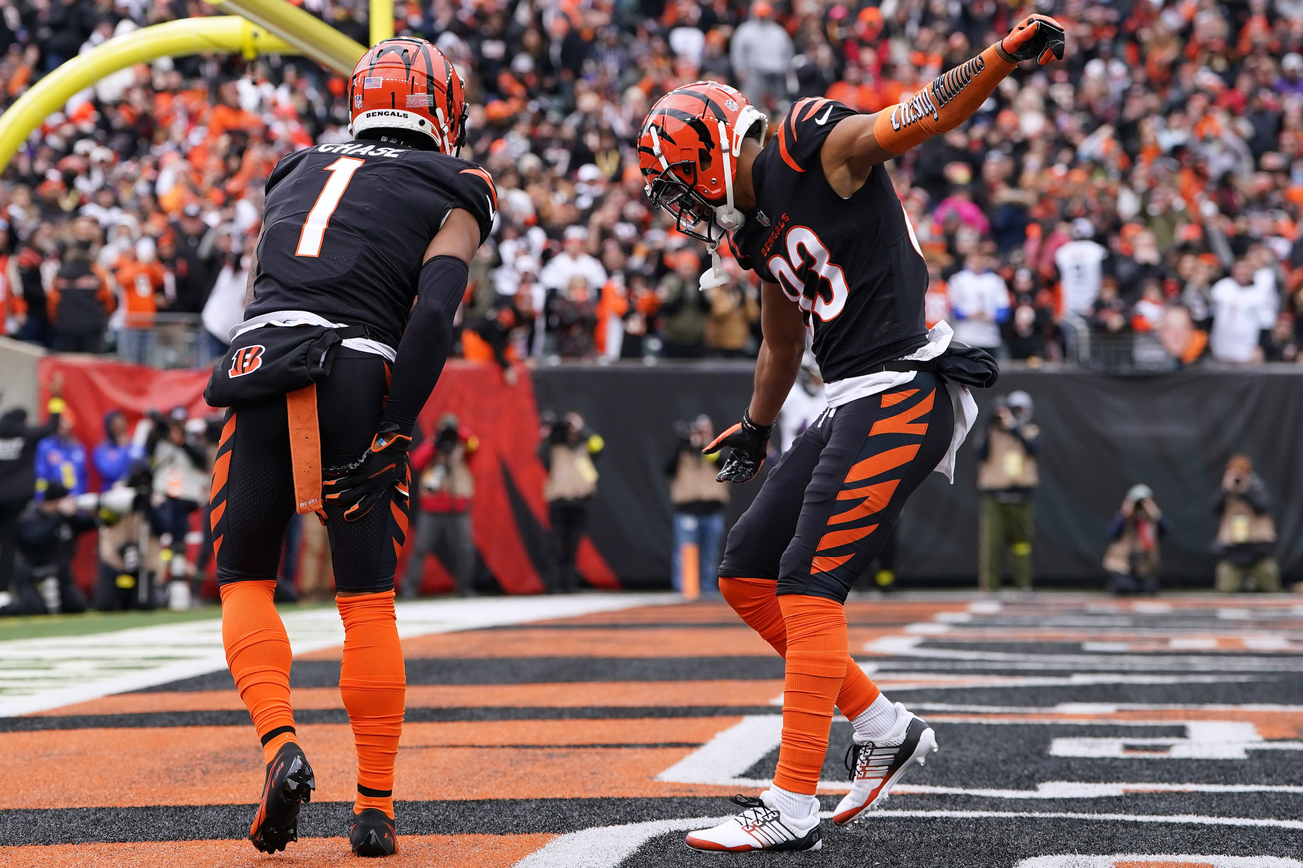 CINCINNATI, OHIO - JANUARY 08: Ja'Marr Chase #1 of the Cincinnati Bengals celebrates his touchdown catch with Tyler Boyd #83 during the second quarter against the Baltimore Ravens at Paycor Stadium on January 08, 2023 in Cincinnati, Ohio. Dylan Buell/Getty Images