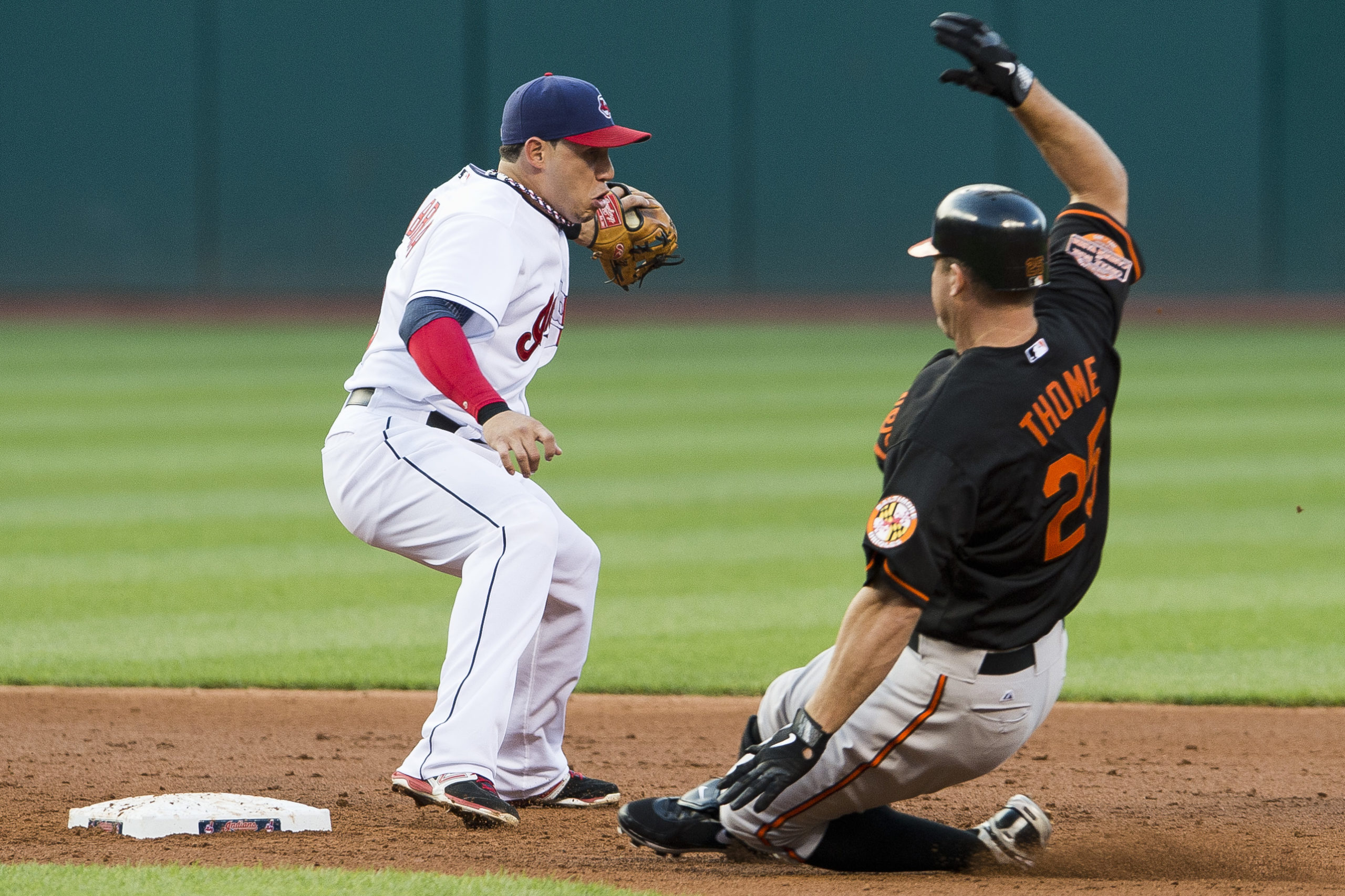 CLEVELAND, OH - JULY 20: Shortstop Asdrubal Cabrera #13 of the Cleveland Indians catches the throw as Jim Thome #25 of the Baltimore Orioles slides into second for a double during the third inning at Progressive Field on July 20, 2012 in Cleveland, Ohio. Jason Miller/Getty Images