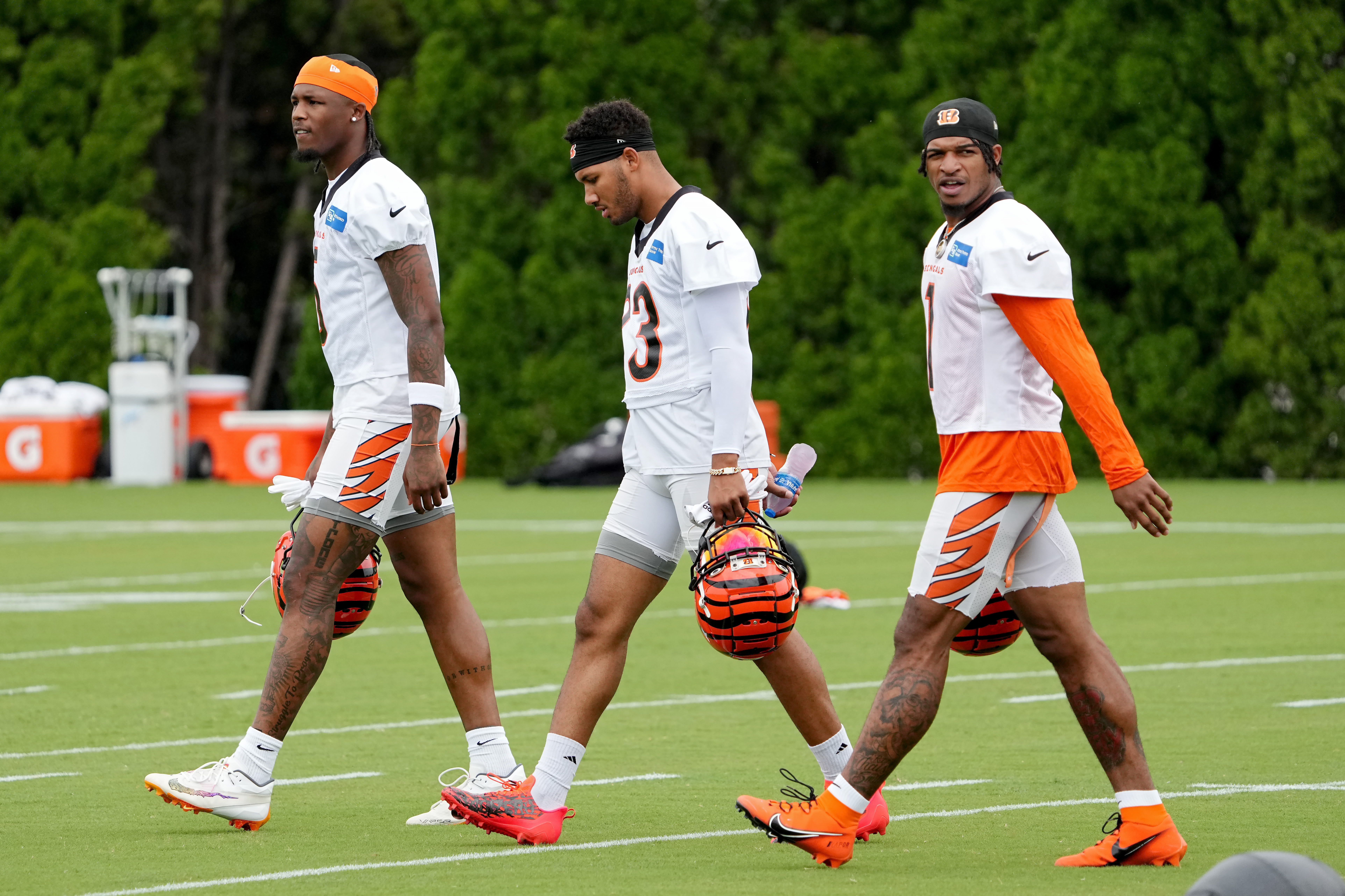 CINCINNATI, OHIO - JULY 26: Tee Higgins #5, Tyler Boyd #83, and Ja'Marr Chase #1 of the Cincinnati Bengals walk across the field during training camp at Kettering Health Practice Fields on July 26, 2023 in Cincinnati, Ohio. Dylan Buell/Getty Images