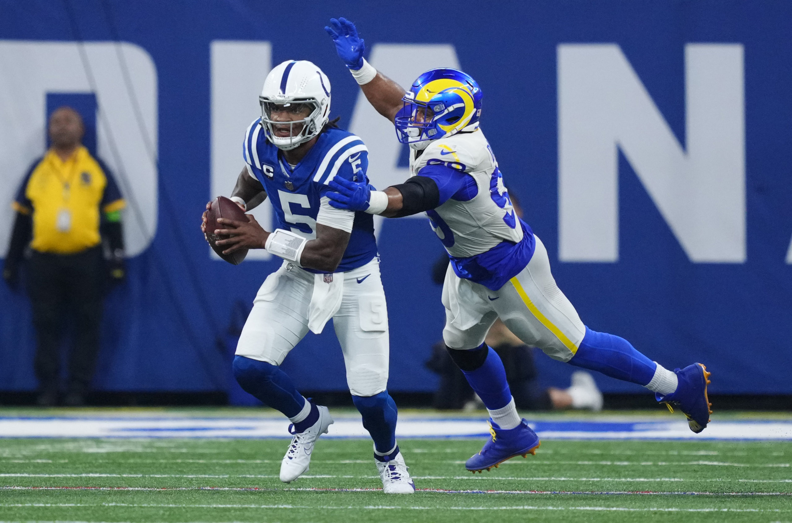 INDIANAPOLIS, INDIANA - OCTOBER 01: Anthony Richardson #5 of the Indianapolis Colts is pressured by Aaron Donald #99 of the Los Angeles Rams during the third quarter at Lucas Oil Stadium on October 01, 2023 in Indianapolis, Indiana. Dylan Buell/Getty Images