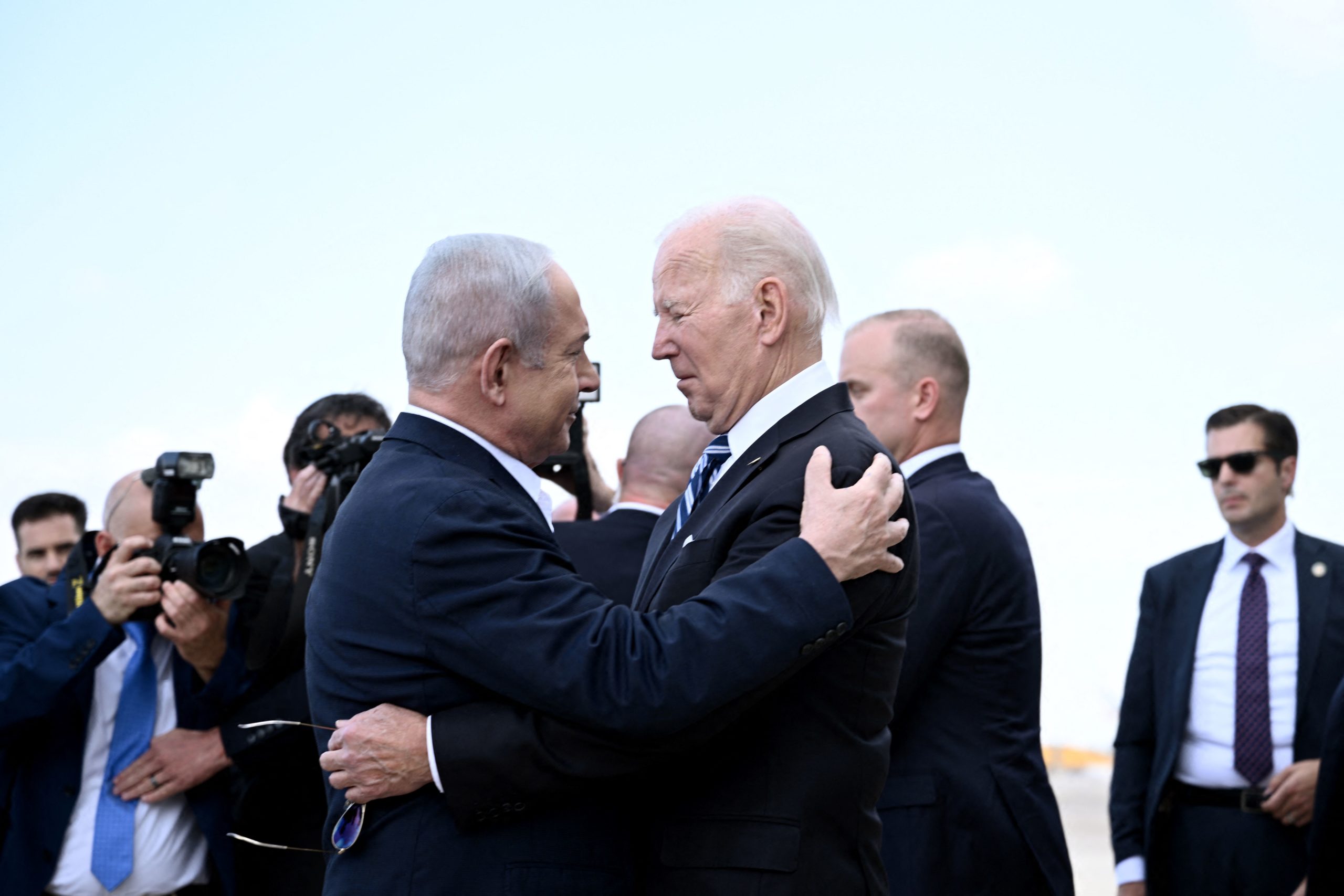 Israel Prime Minister Benjamin Netanyahu (L) greets US President Joe Biden upon his arrival at Tel Aviv's Ben Gurion airport on October 18, 2023, amid the ongoing battles between Israel and the Palestinian group Hamas. Biden landed in Israel on October 18, on a solidarity visit following Hamas attacks that have led to major Israeli reprisals. Thousands of people, both Israeli and Palestinians have died since October 7, 2023, after Palestinian Hamas militants based in the Gaza Strip, entered southern Israel in a surprise attack leading Israel to declare war on Hamas in Gaza on October 8. (Photo by Brendan SMIALOWSKI / AFP) (Photo by BRENDAN SMIALOWSKI/AFP via Getty Images)